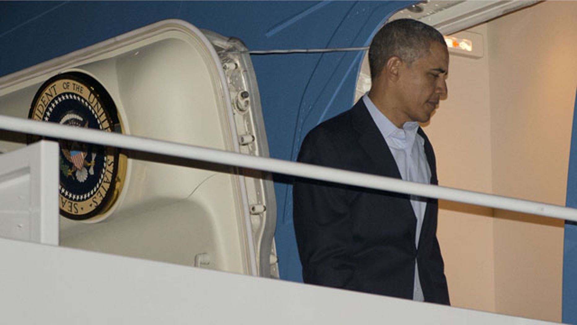 March 23, 2014: President Barack Obama boards Air Force One before his departure from Andrews Air Force Base. Obama was traveling to the Nuclear Security Summit in The Hague, Netherlands, which will form the backdrop for an emergency meeting of Group of Seven leaders on Russia's annexation of Crimea. (AP Photo/Pablo Martinez Monsivais)
