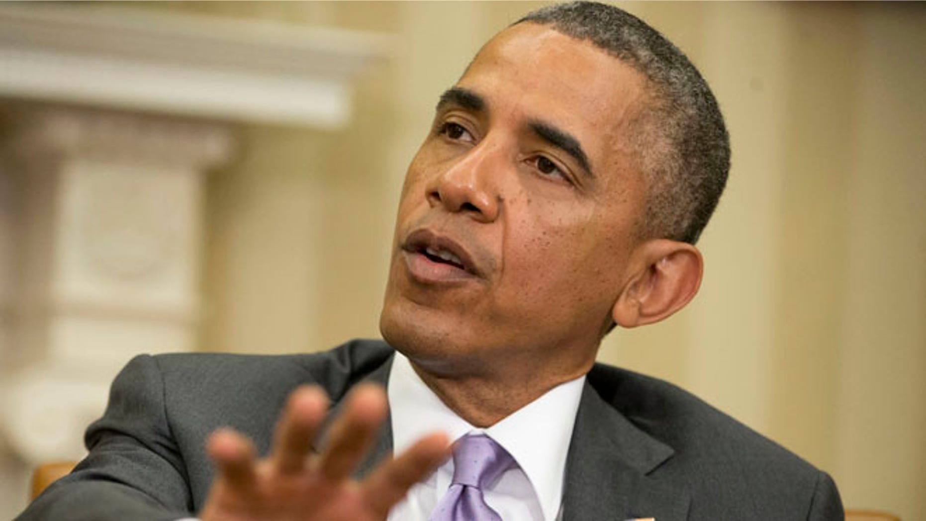 This June 12, 2014 file photo shows President Barack Obama speaking in the Oval Office of the White House in Washington.
