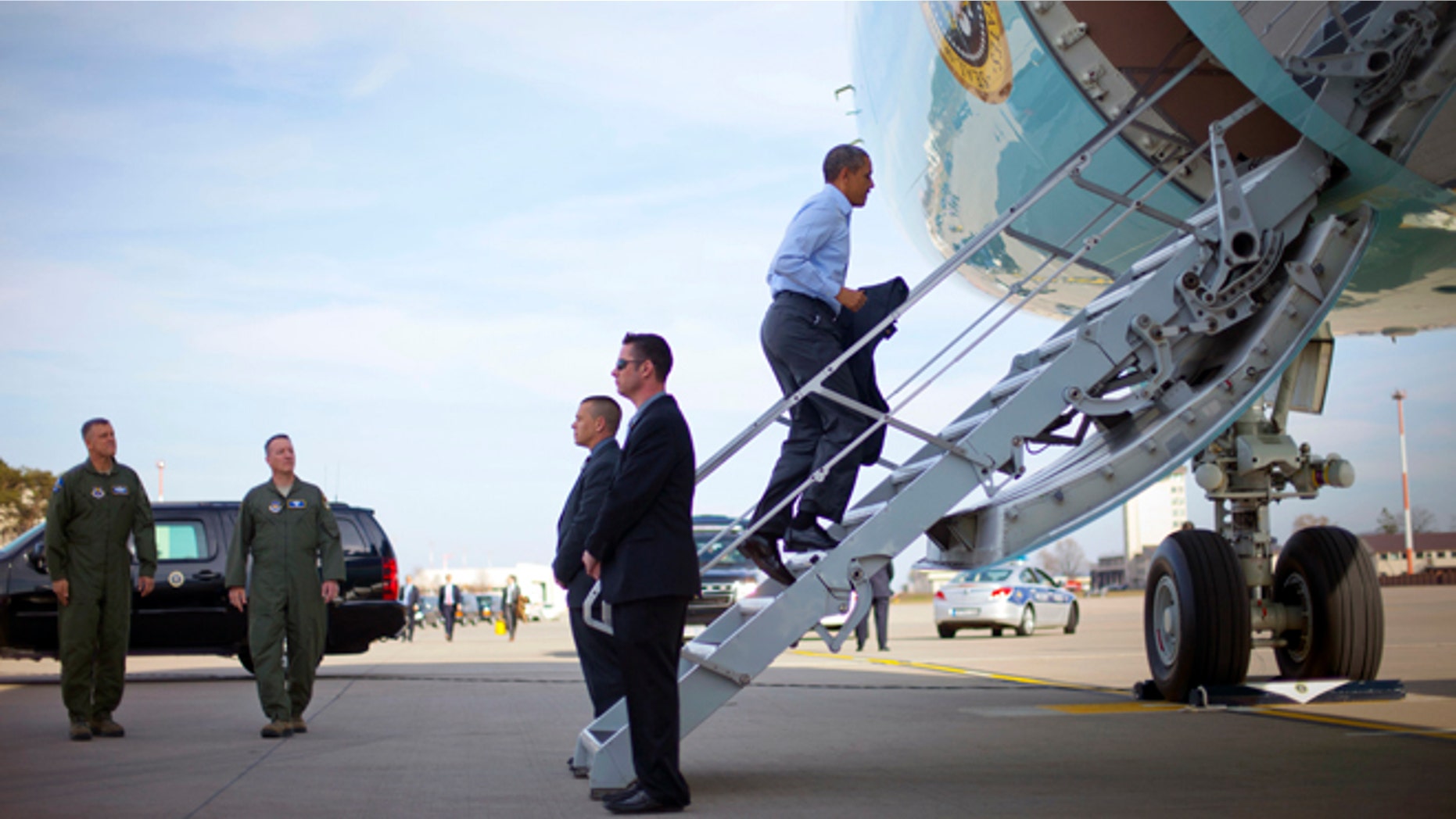 U.S. President Barack Obama boards Air Force One at Ramstein Air Base, Saturday, March 29, 2014, in Germany. Air Force One was making a scheduled refueling stop in Germany and he was using the opportunity to meet with US members of the military. Obama is returning back to Washington after a week long trip aboard to Europe and Saudi Arabia. (AP Photo/Pablo Martinez Monsivais)