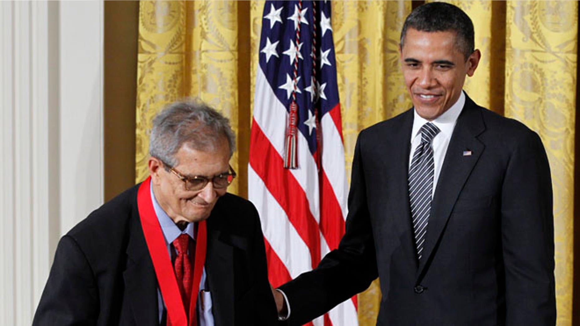 President Barack Obama helps Economist Amartya Sen after presenting him with a 2011 National Humanities Medal to Indian , Monday, Feb., 13, 2012, in the East Room of the White House in Washington. (AP Photo/Pablo Martinez Monsivais)