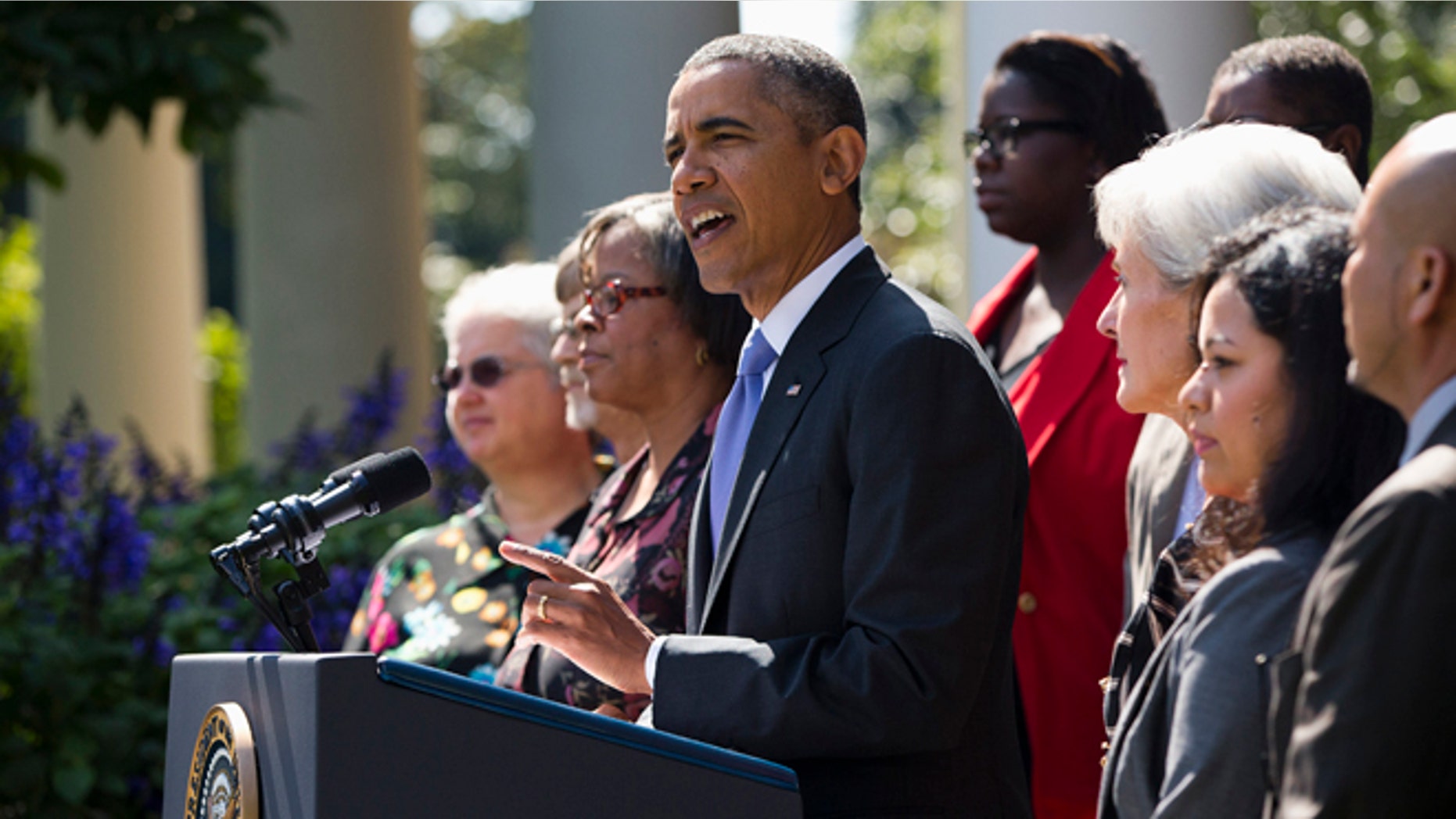 President Barack Obama gestures while speaking in the Rose Garden of the White House in Washington, Tuesday, Oct. 1, 2013, to talk about the government shutdown. Congress plunged the nation into a partial government shutdown Tuesday as a protracted dispute over Obama's signature health care law reached a boiling point, forcing some 800,000 federal workers off the job. (AP Photo/ Evan Vucci)