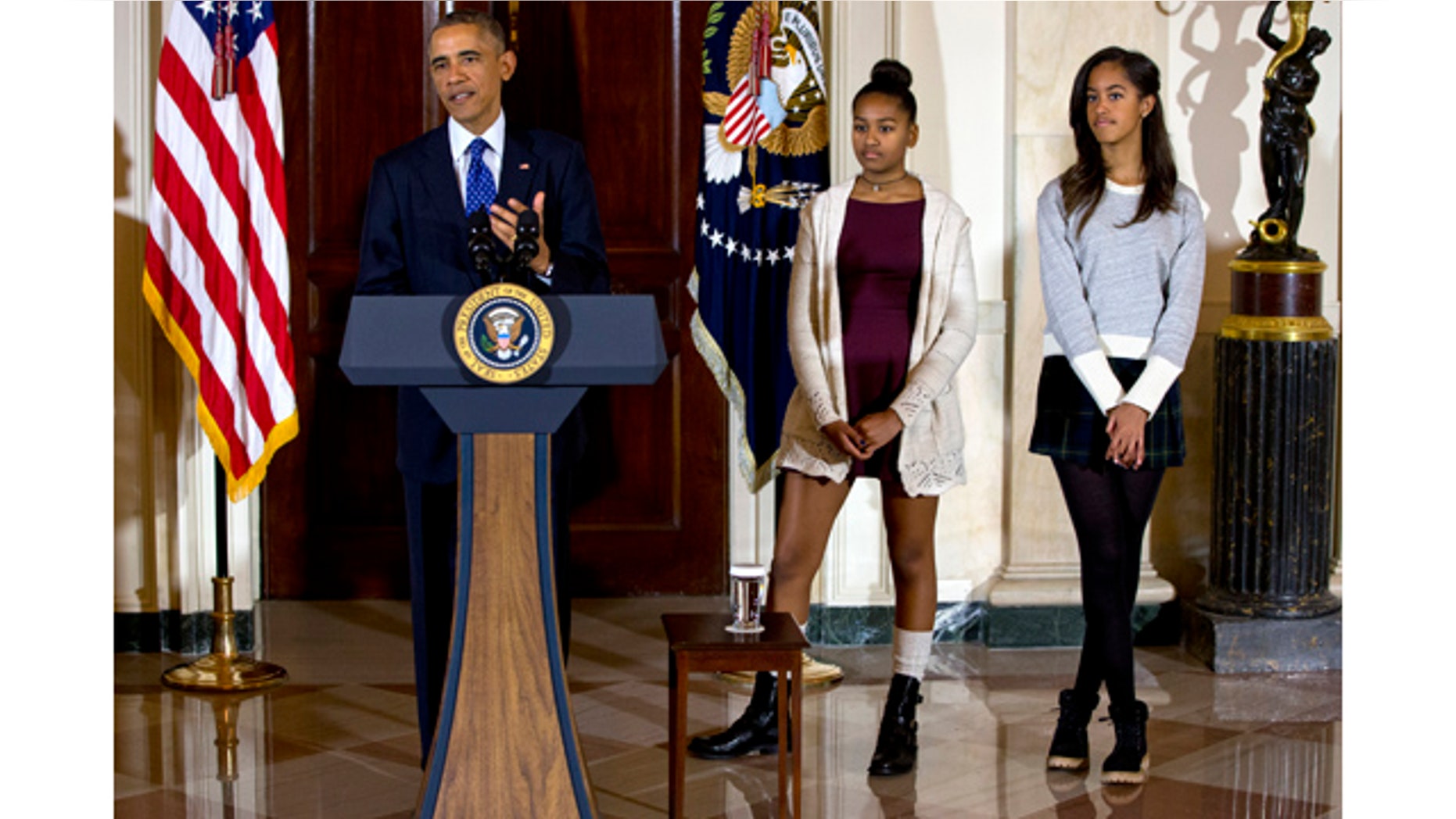 November 26, 2014: President Barack Obama, joined by his daughters Malia, right, and Sasha, center, speaks during the presidential turkey pardon ceremony at the White House. (AP Photo/Jacquelyn Martin)