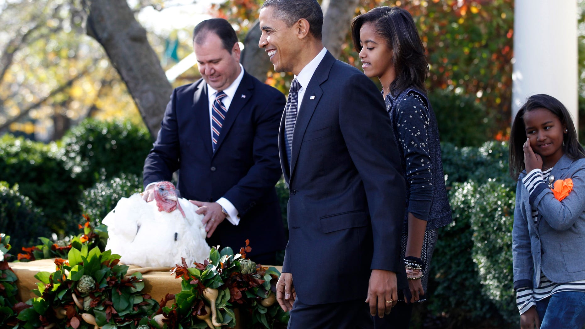 Nov. 24: President Barack Obama, walks with daughters Malia Obama and Sasha Obama after he pardoned Apple, the National Thanksgiving Turkey, during a ceremony in the Rose Garden of the White House.