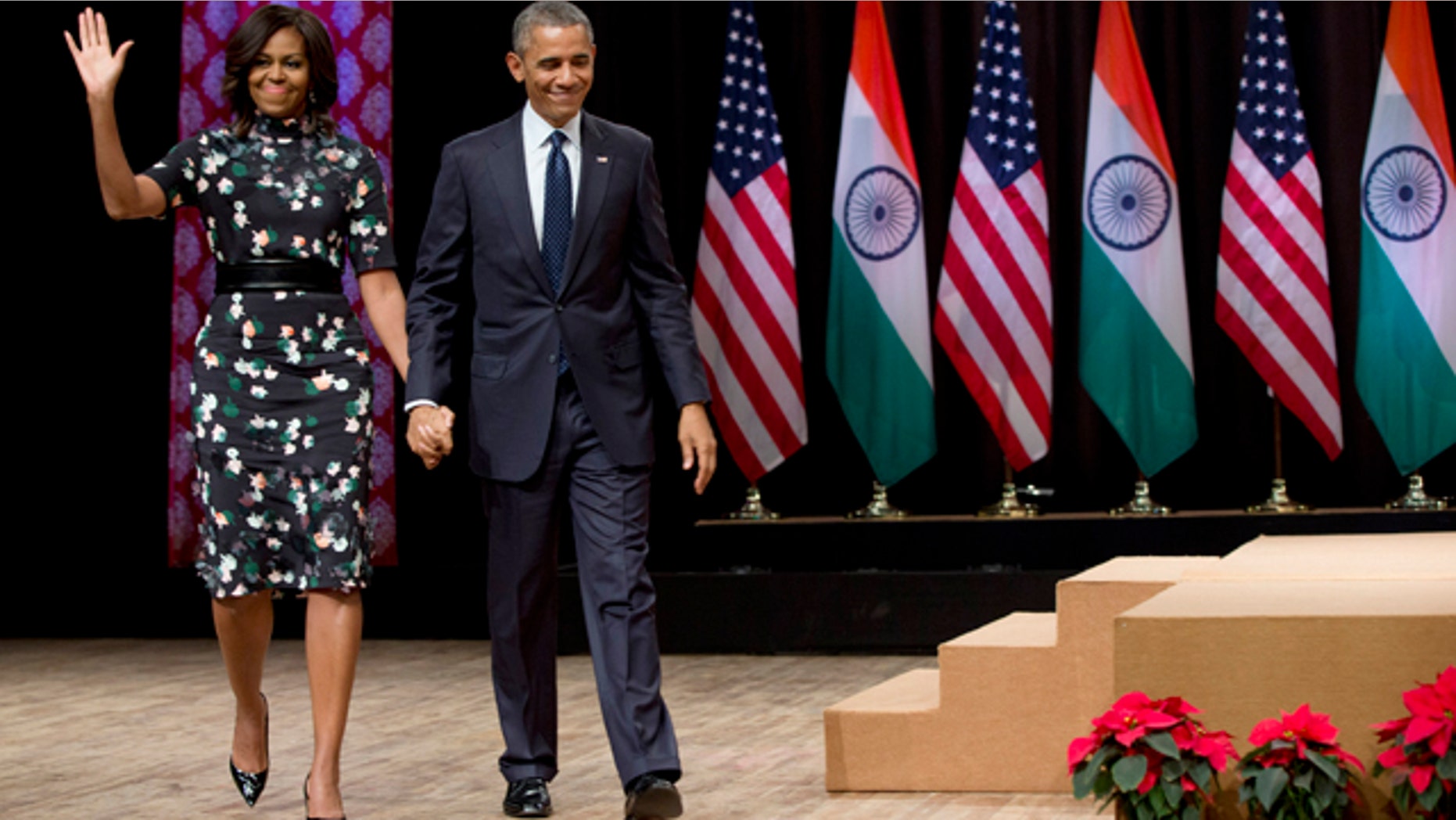 Jan. 27, 2015: President Barack Obama walks from the stage with first lady Michelle Obama after his speech at the Siri Fort Auditorium in New Delhi, India. (AP Photo/Carolyn Kaster)