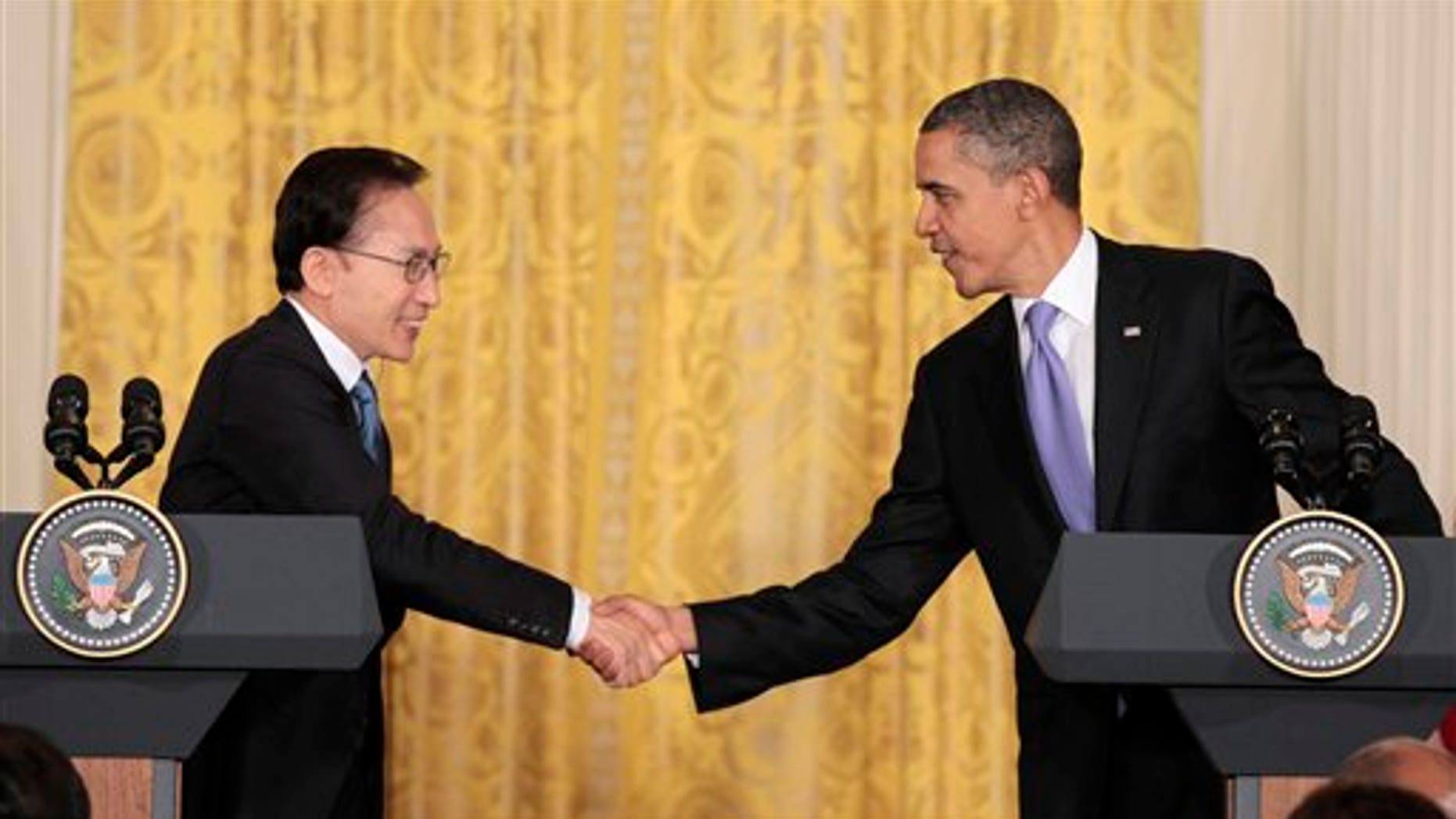 October 13: President Barack Obama and South Korean President Lee Myung-bak shake hands during their joint news conference in the East Room at the White House in Washington, D.C.