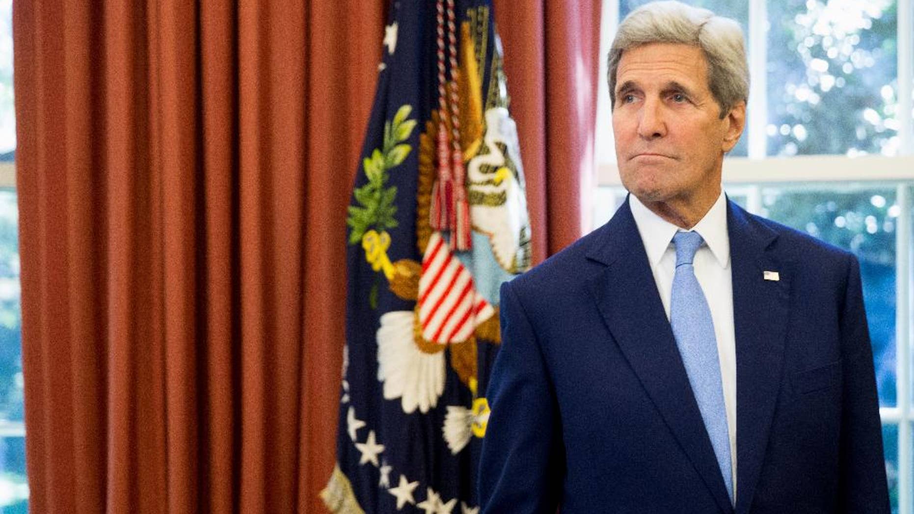 Secretary of State John Kerry is seen in the Oval Office of the White House in Washington, Tuesday, Sept. 15, 2015, as President Barack Obama and Spain's King Felipe VI conclude a bilateral meeting. (AP Photo/Andrew Harnik)
