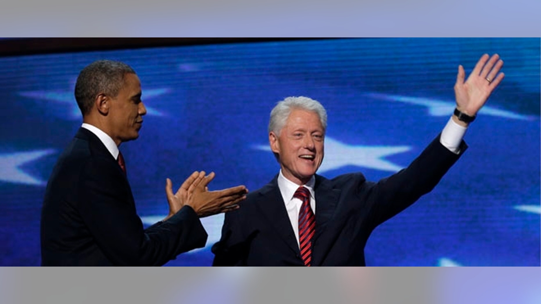 Former President Bill Clinton waves after addressing the Democratic National Convention as President Barack Obama greets in Charlotte, N.C., on Wednesday, Sept. 5, 2012. (AP Photo/Charles Dharapak)