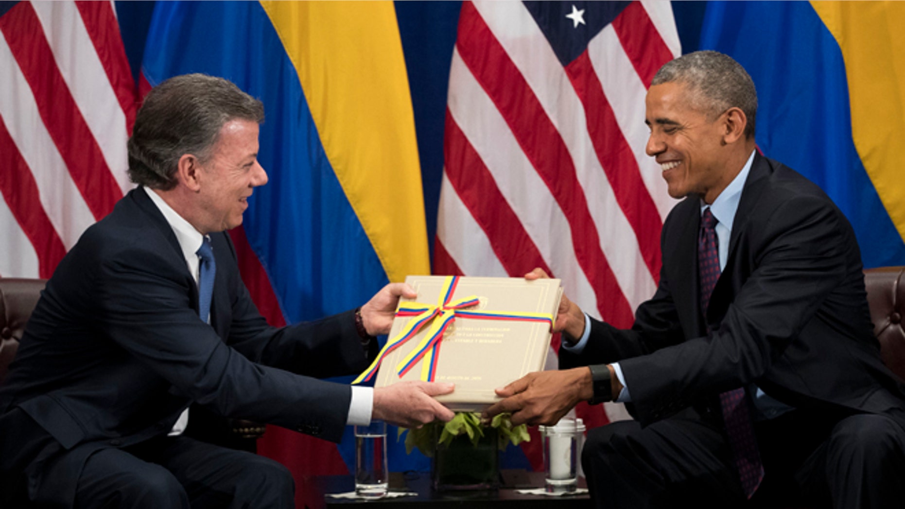 NEW YORK, NEW YORK - SEPTEMBER 21: (L to R) President of Colombia Juan Manuel Santos gives U.S. President Barack Obama a copy of the Colombian peace agreement during bilateral meeting at the Lotte New York Palace Hotel, September 21, 2016 in New York City. In Tuesday's speech to the United Nations General Assembly, Obama stated that 'helping Colombia end Latin America's longest war' was among his major accomplishments as president. Last month, the Colombian government reached a peace agreement with the Revolutionary Armed Forces of Colombia (FARC). (Photo by Drew Angerer/Getty Images)
