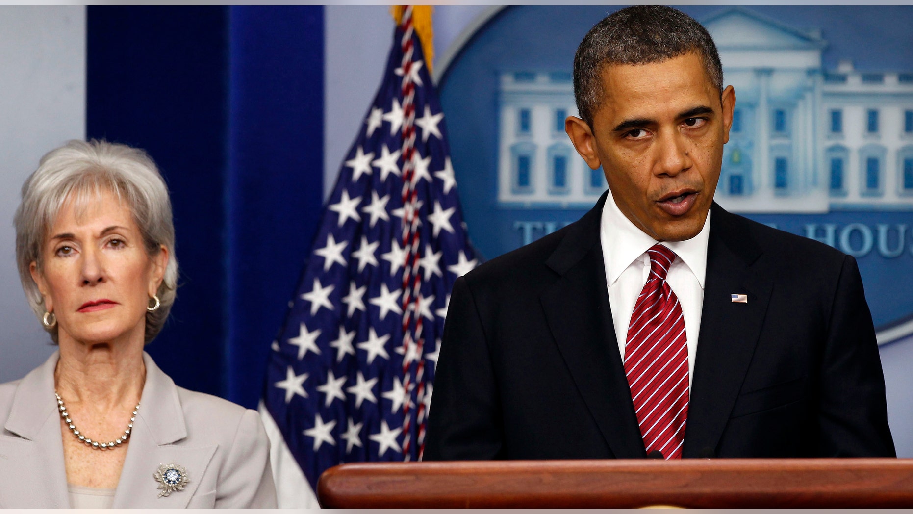U.S. President Barack Obama makes a statement next to Secretary of HHS Kathleen Sebelius about contraceptive care funding in the press room of the White House in Washington.