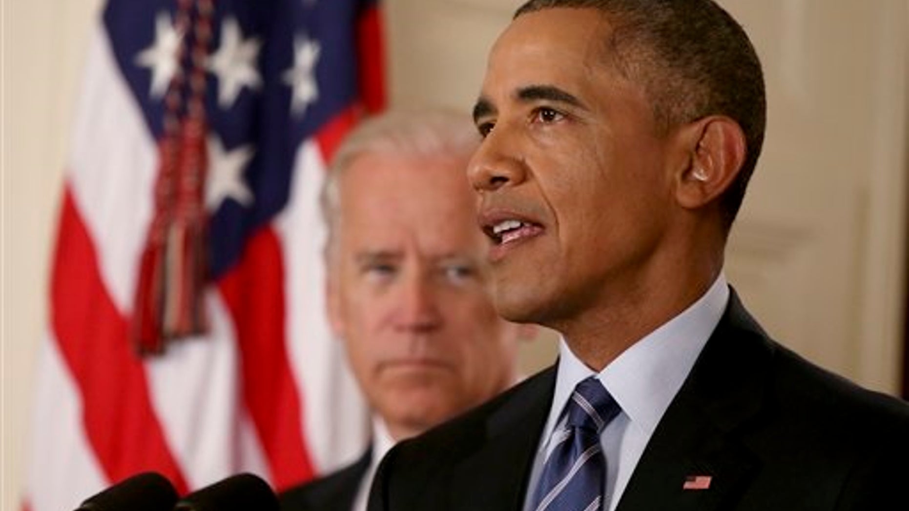 President Barack Obama, standing with Vice President Joe Biden, delivers remarks in the East Room of the White House in Washington, Tuesday, July 14, 2015, after an Iran deal is reached. Obama says every path to a nuclear weapon will be cut off from Iran under a historic agreement announced in Vienna. (AP Photo/Andrew Harnik, Pool)