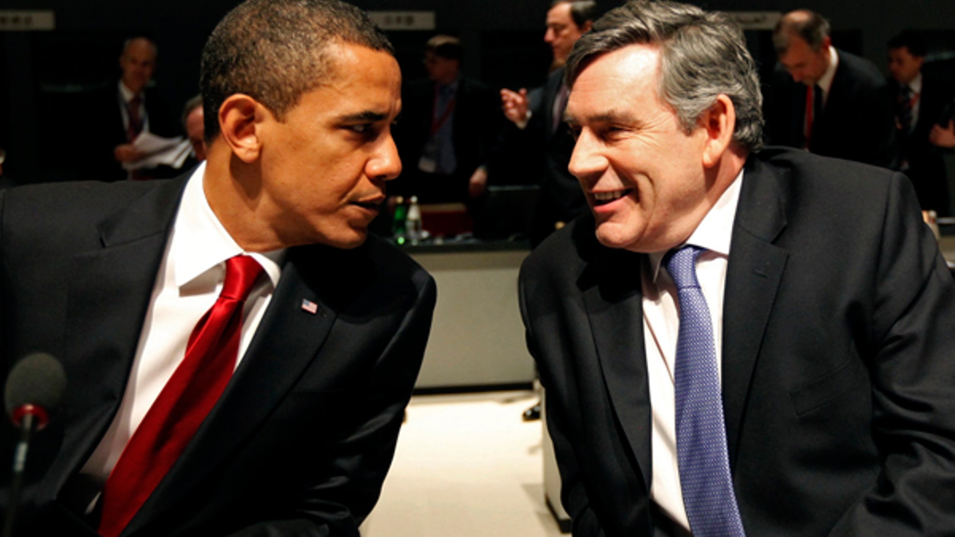 In this photo from April 2, 2009 U.S President Barack Obama (L) speaks to Britain's then Prime Minister Gordon Brown before the start of the Plenary Session at the G20 summit at the ExCel centre, in east London.