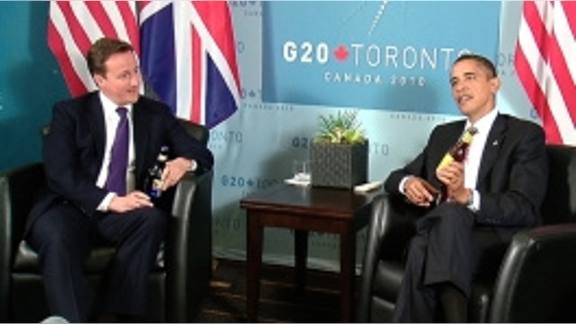 President Obama and British Prime Minister David Cameron exchange beers following a World Cup bet, June 26, 2010 (White House Photo)