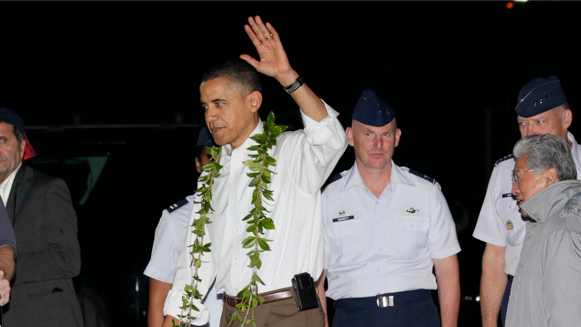 Dec. 22: Obama waves after deplaning from Force One as he arrives at Hickam Air Force Base in Honolulu to start his vacation.