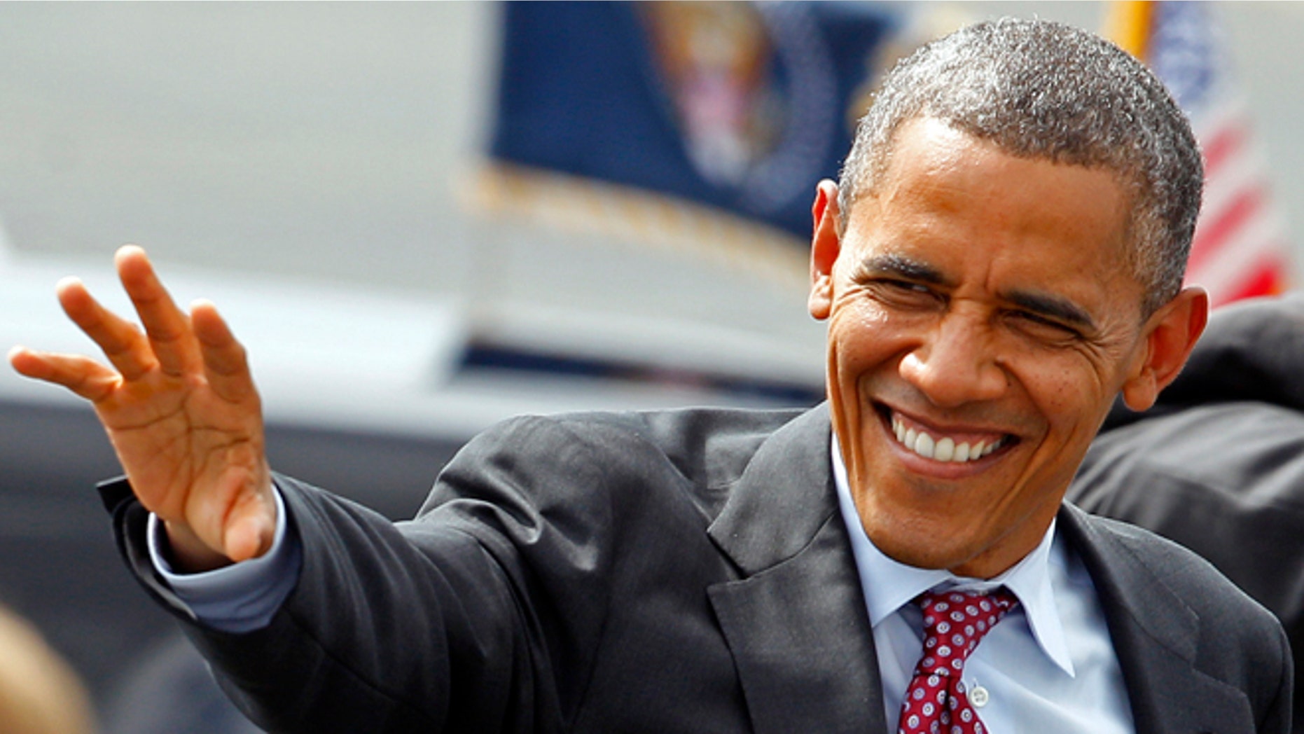 President Barack Obama waves to supporters as he arrives at the Charlotte/Douglas International Airport for the Democratic National Convention in Charlotte, N.C., Wednesday, Sept. 5, 2012. (AP Photo/Chuck Burton)