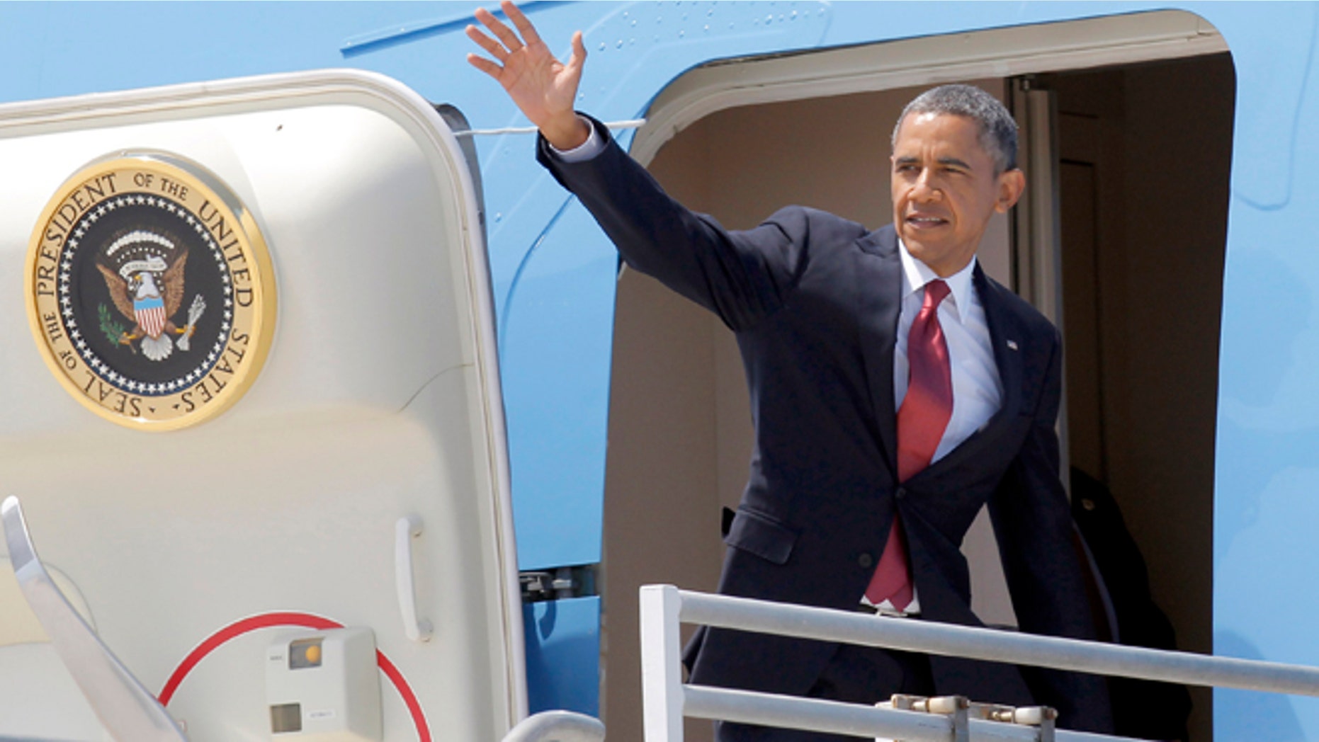 Aug 7, 2013: President Barack Obama waves from the door of Air Force One for his return to Washington, after a two-day swing through Southern California, at Los Angeles International Airport.