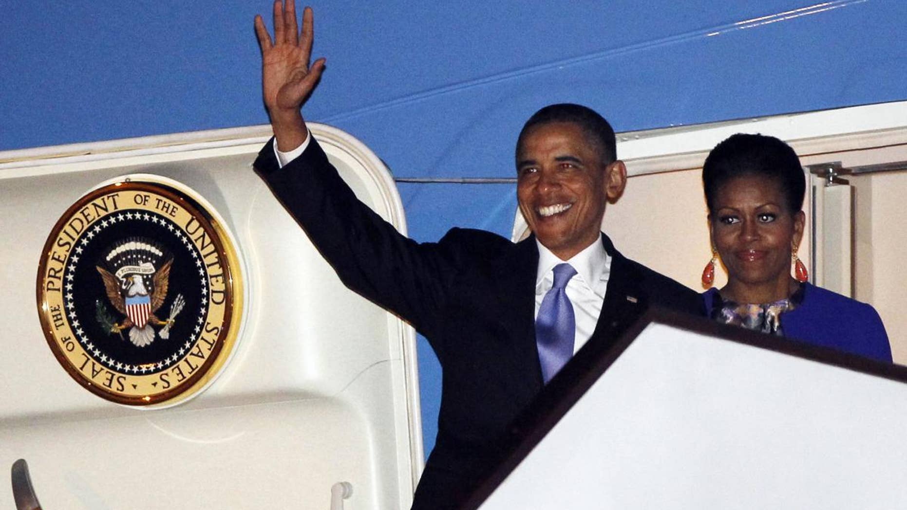 U.S. President Barack Obama and first lady Michelle Obama step off Air Force One as they arrive at London's Stansted Airport, Monday, May 23, 2011. (AP Photo/Charles Dharapak)