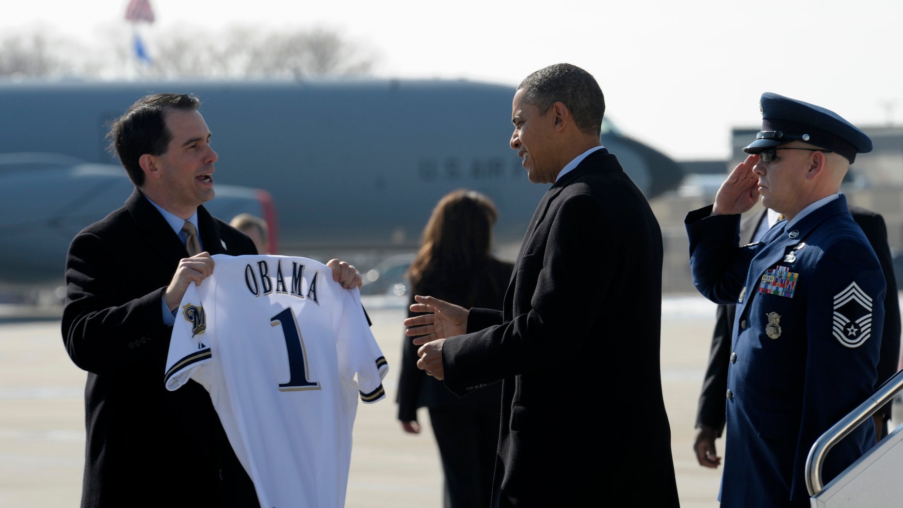 Feb. 15: Wisconsin Gov. Scott Walker presents President Barack Obama with a Milwaukee Brewers baseball jersey upon his arrival at General Mitchell International Airport in Milwaukee.