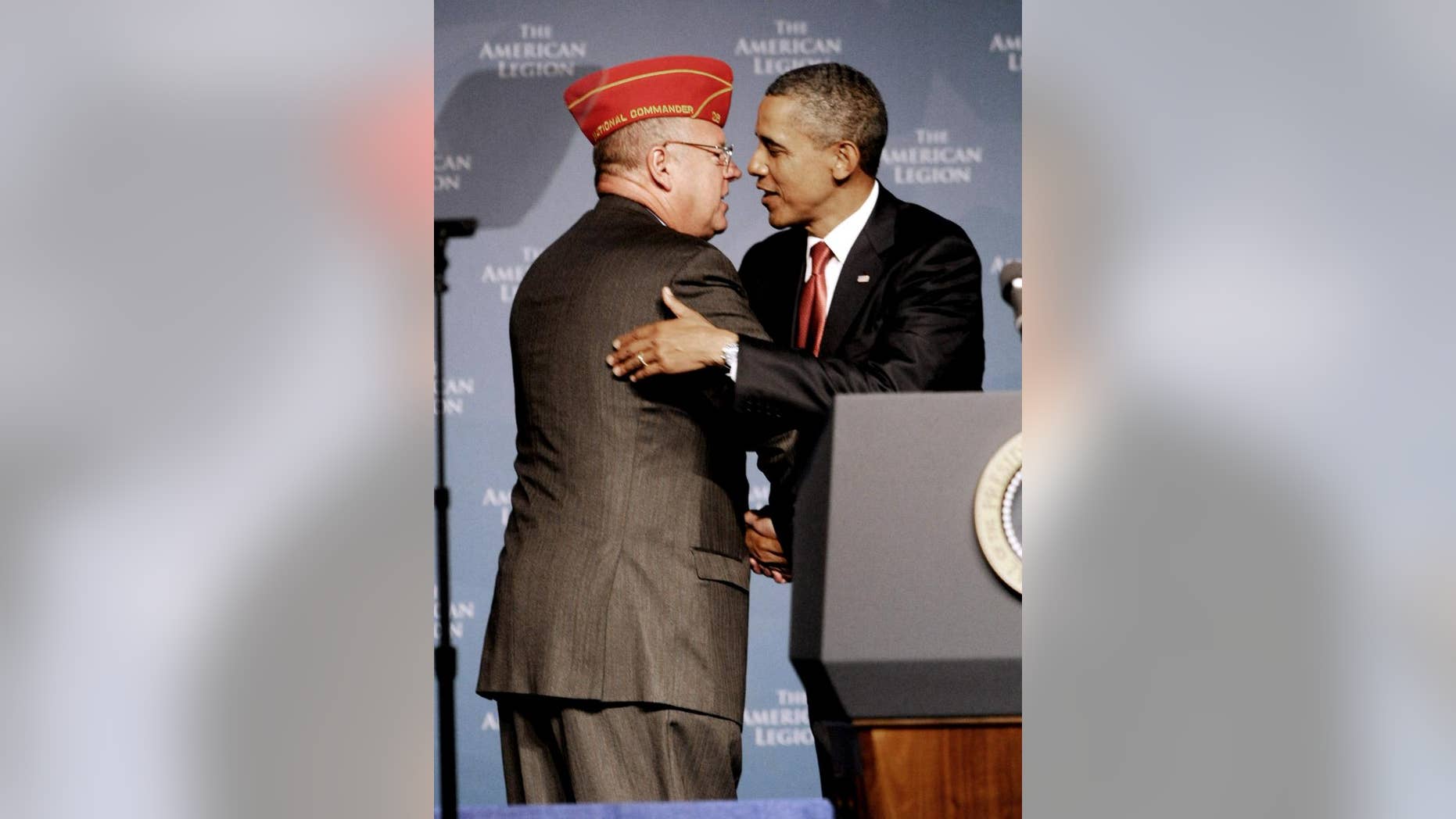 President Barack Obama, right, is greeted by Jimmie Foster, national commander of the American Legion prior to Obama's address to its national convention, Tuesday, Aug. 30, 2011, in Minneapolis. (AP Photo/Jim Mone)