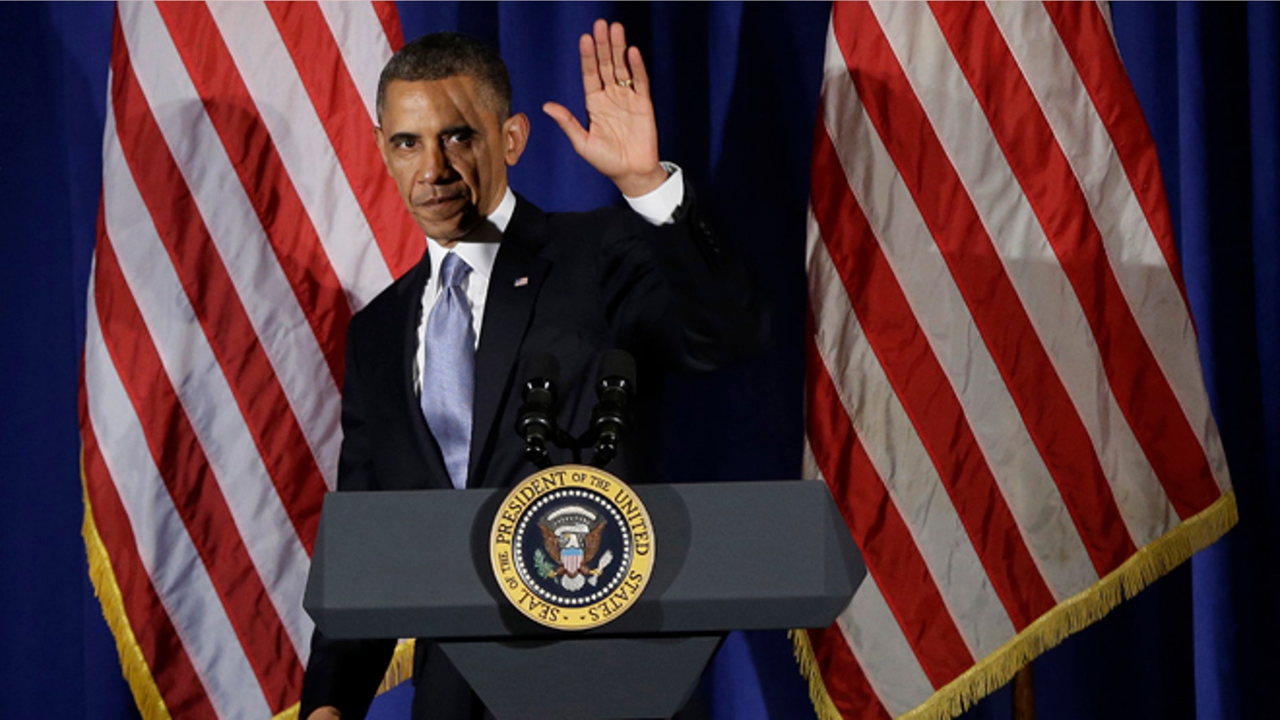May 13, 2013: President Barack Obama waves as he steps off stage after speaking at a Democratic fundraiser at the Waldorf Astoria Hotel in New York.