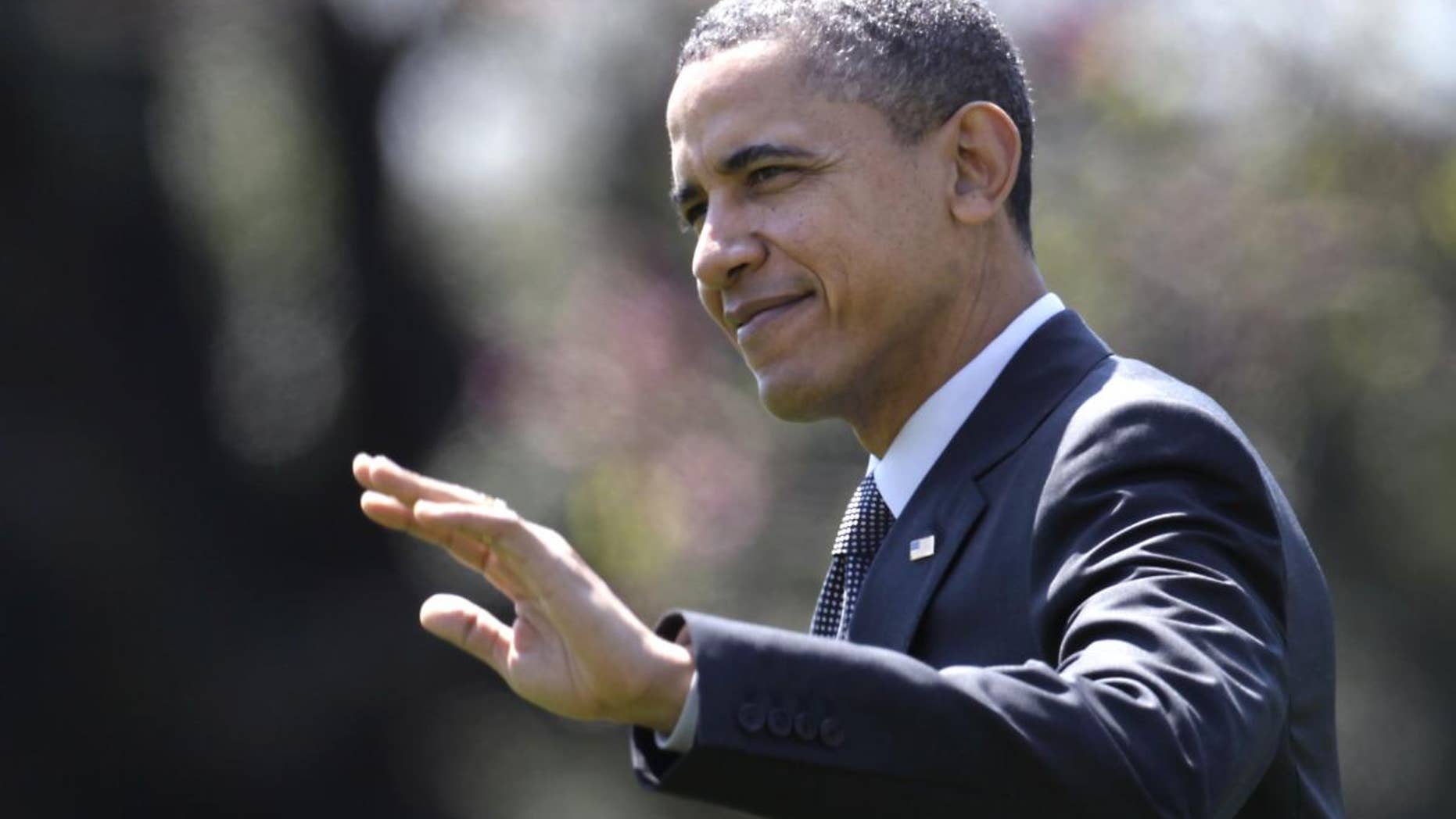 President Barack Obama waves as he walks across the South Lawn of the White House in Washington, Wednesday, April 6, 2011, to board Marine One as he travels to Pennsylvania. (AP Photo/Carolyn Kaster)