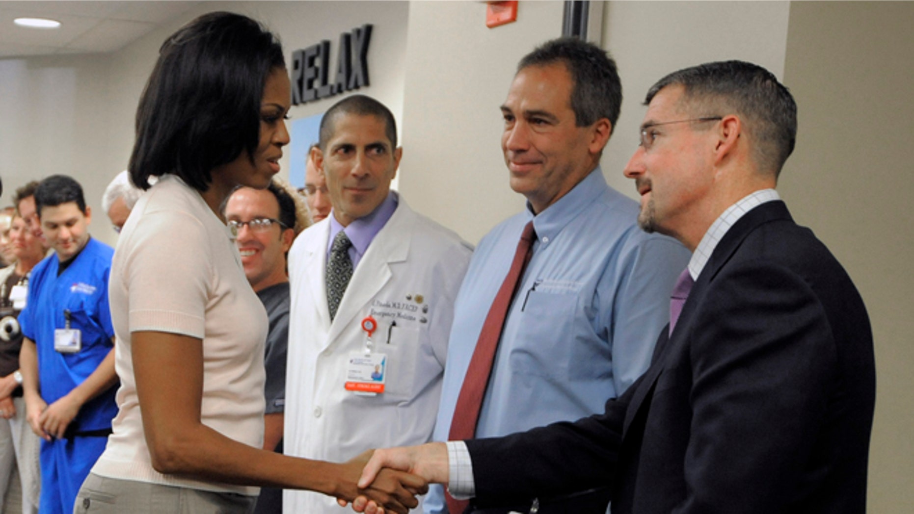 Aug. 11: First lady Michelle Obama shakes hands with Dr. James Denton, a first responder to the Aurora theater shooting, at The Medical Center of Aurora.