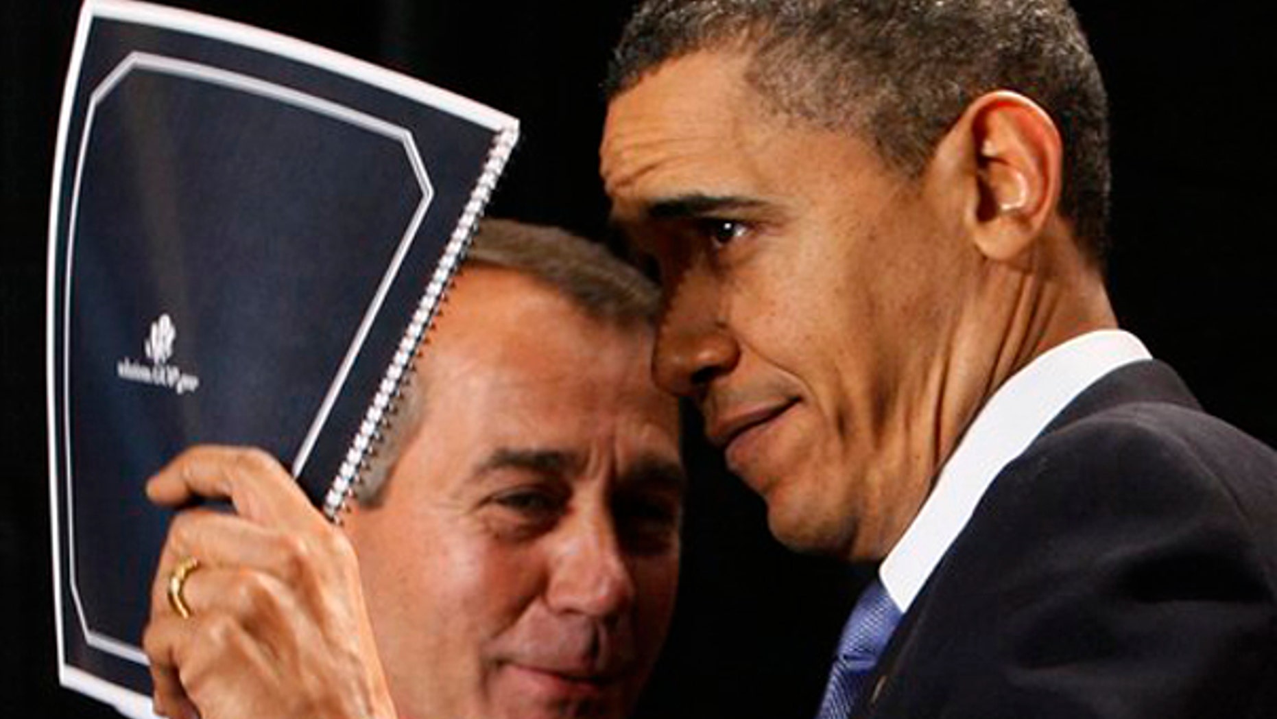 President Barack Obama holds up a document of Republican solutions given to him by House Minority Leader John Boehner of Ohio, before he spoke to Republican lawmakers at the GOP House Issues Conference in Baltimore, Friday, Jan. 29, 2010. (AP Photo/Charles Dharapak)
