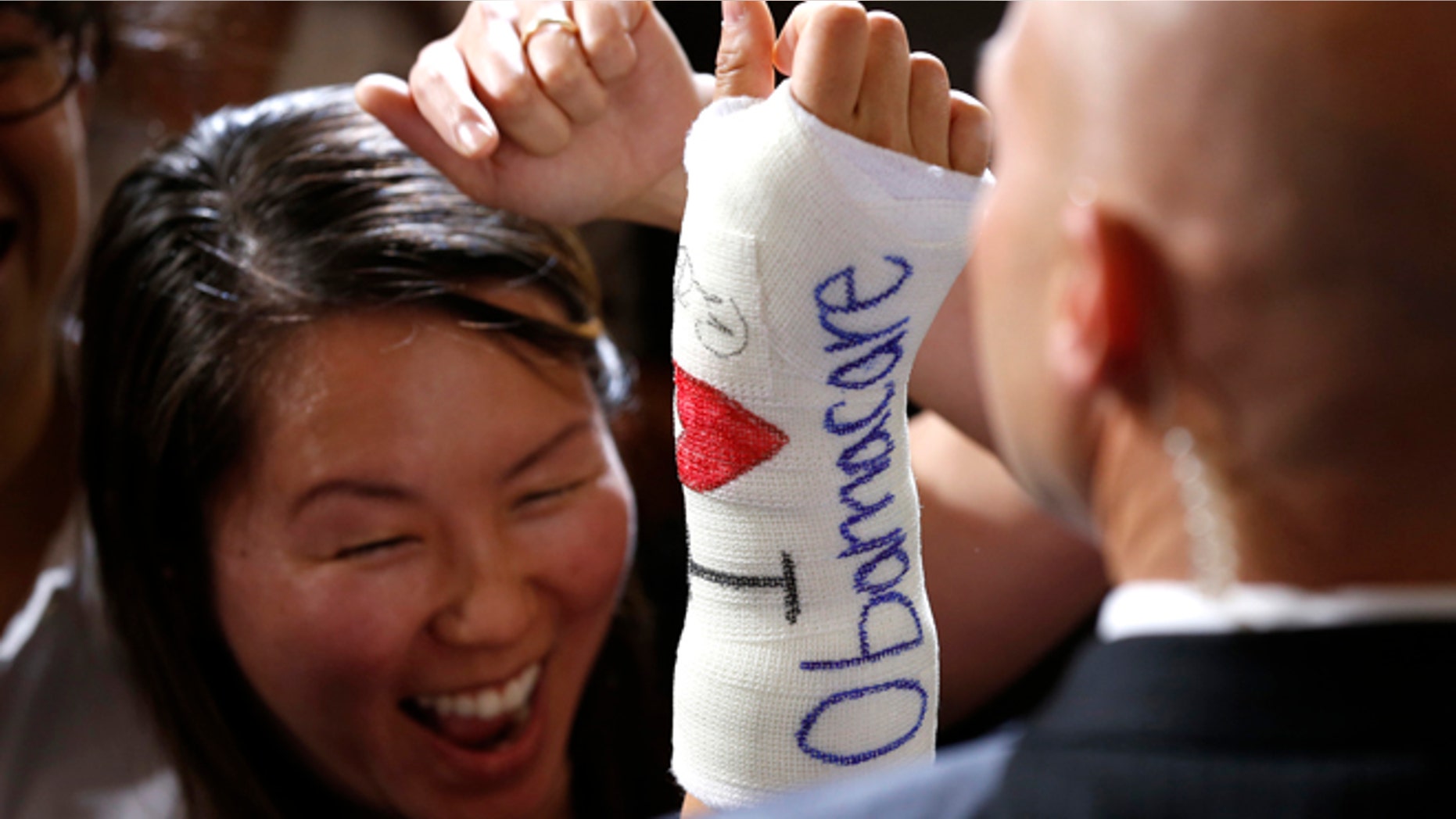 FILE: October 30, 2013: A Massachusetts woman after President Obama signed her cast in Boston, Mass.