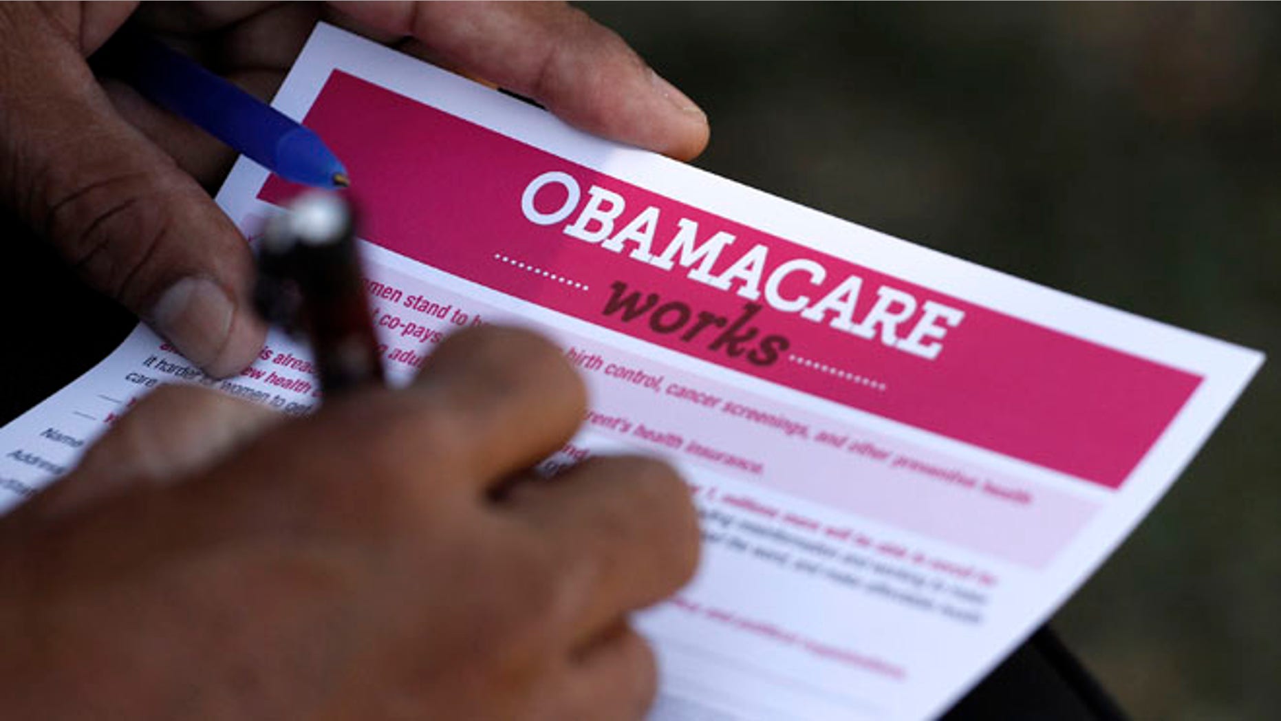 FILE: September 28, 2013. A man fills out an information card during an Affordable Care Act outreach event hosted by Planned Parenthood for the Latino community in Los Angeles, Calif.