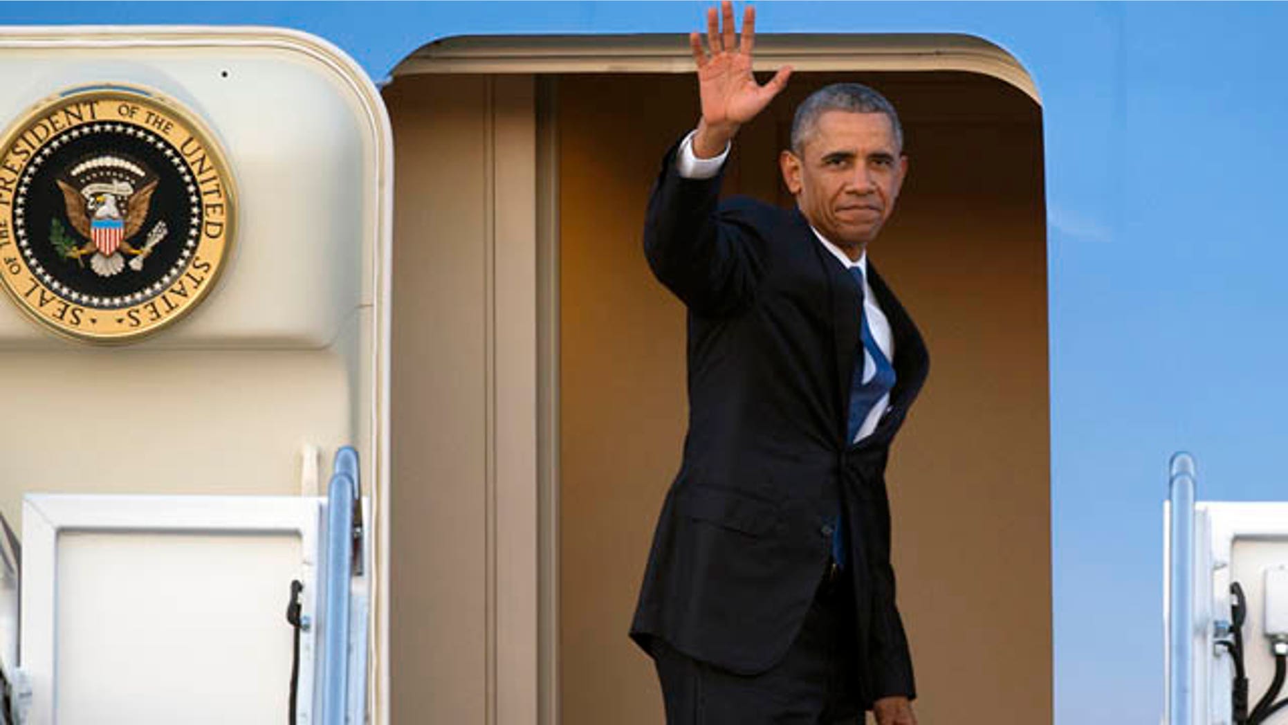 July 23, 2015: President Barack Obama waves as he boards Air Force One for a trip to Kenya and Ethiopia. Obama is the first sitting U.S. president to visit both countries. (AP Photo/Cliff Owen)