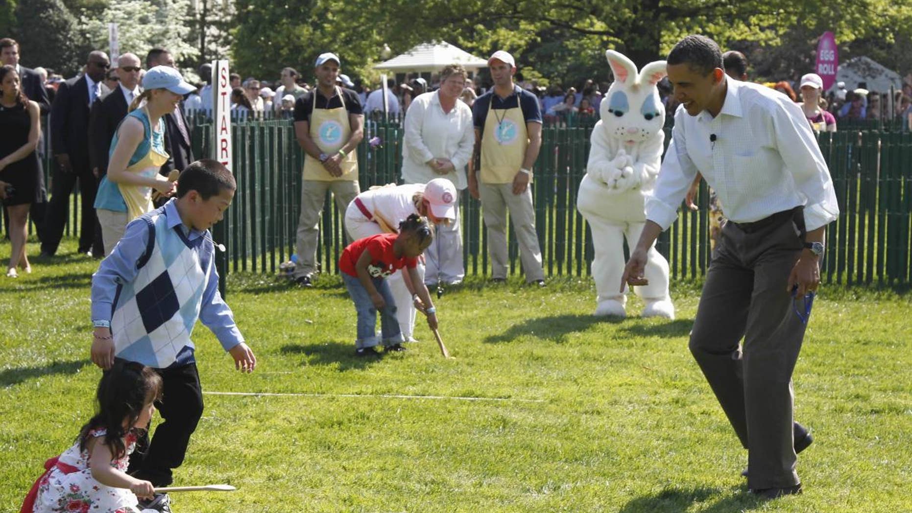President Barack Obama cheers on children rolling Easter eggs at the White House Easter Egg Roll on the South Lawn of the White House in Washington, Monday, April 25, 2011. (AP Photo/Charles Dharapak)