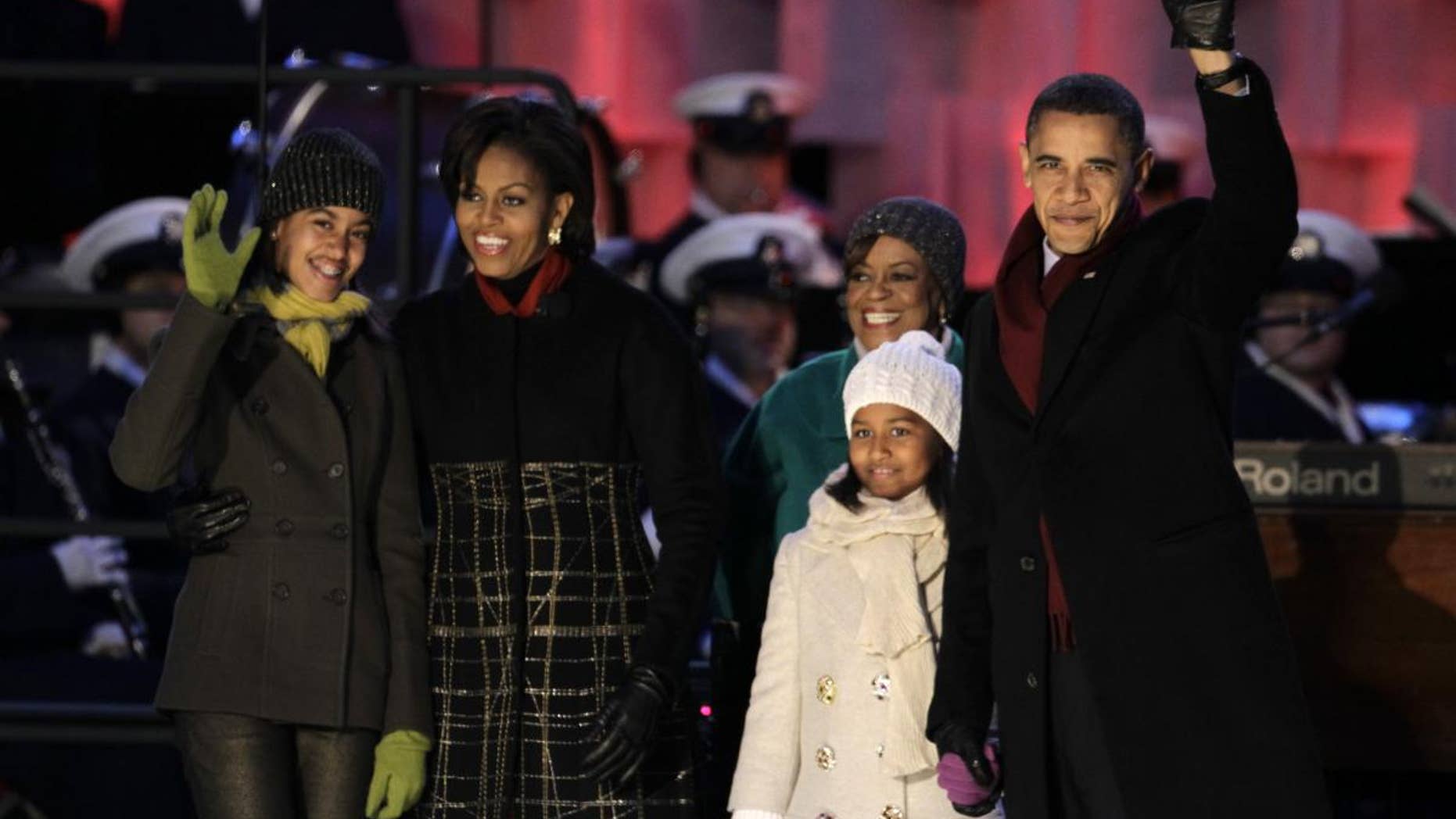 President Barack Obama, first lady Michelle Obama, daughters Malia and Sasha Obama, and mother-in-law Marian Robinson arrive for the lighting of the National Christmas Tree at the Ellipse across from the White House in Washington, Thursday, Dec. 9, 2010. (AP Photo/Charles Dharapak)