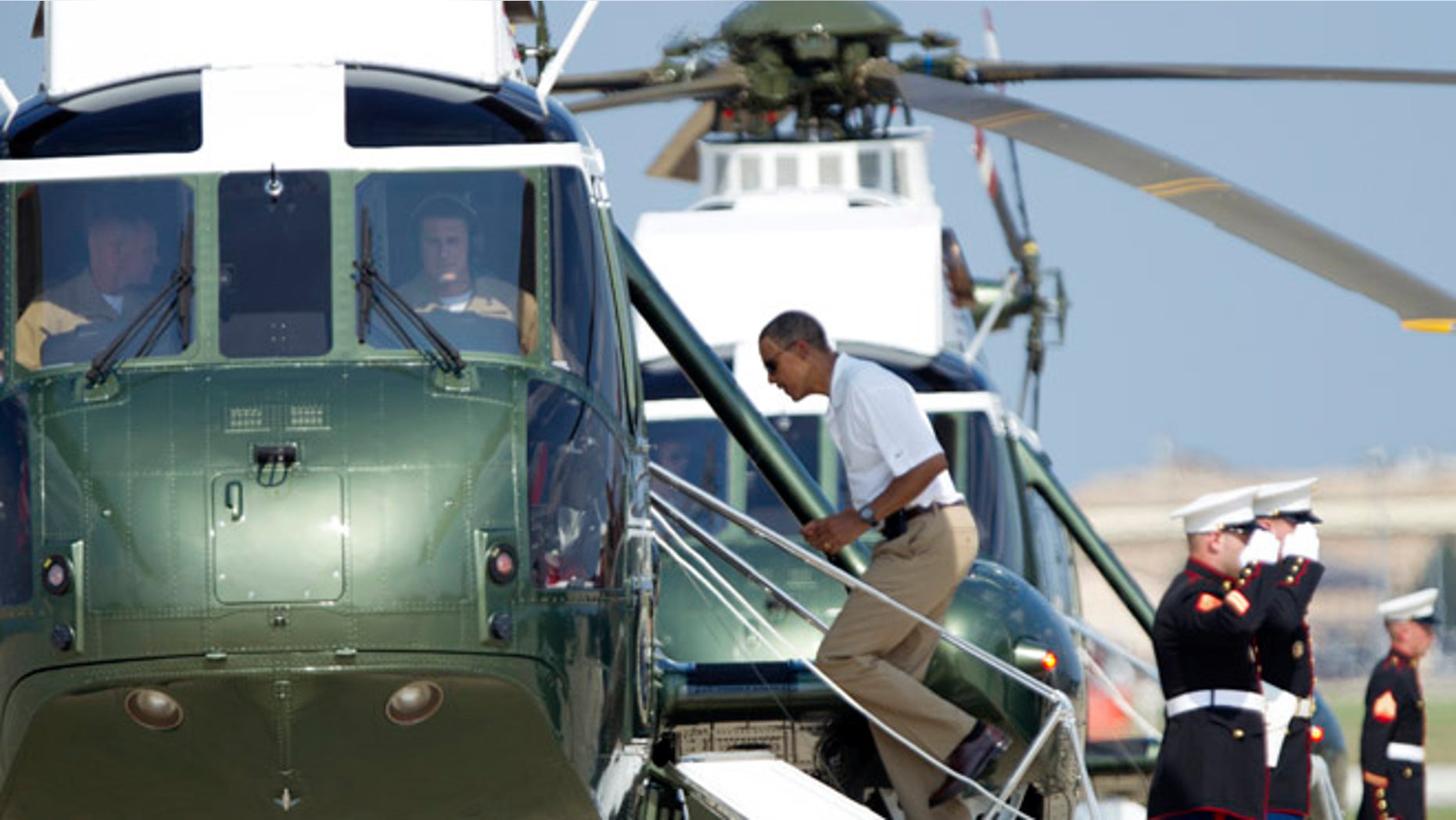 Aug. 4, 2012: President Barack Obama boards Marine One helicopter as he departs Andrews Air Force Base, Md., for Camp David.