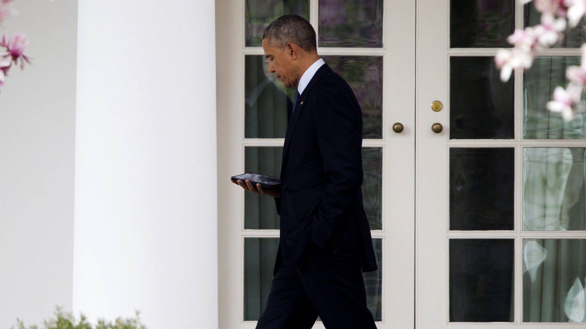 President Obama walks back to the Oval Office of the White House in Washington, Tuesday, April 7, 2015.