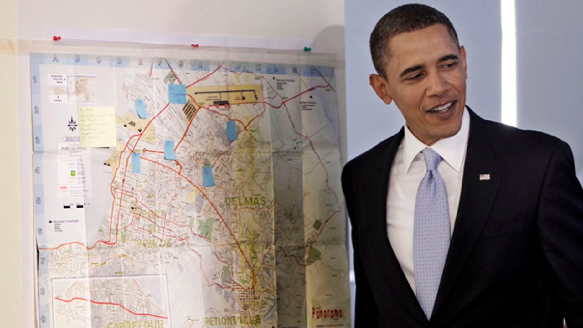 Monday: President Obama stands by a street map of Port-Au-Prince, Haiti, during a visit to the Red Cross Disaster Operation center in Washington. He will deliver his first State of the Union address on Wed., Jan. 27. (AP)