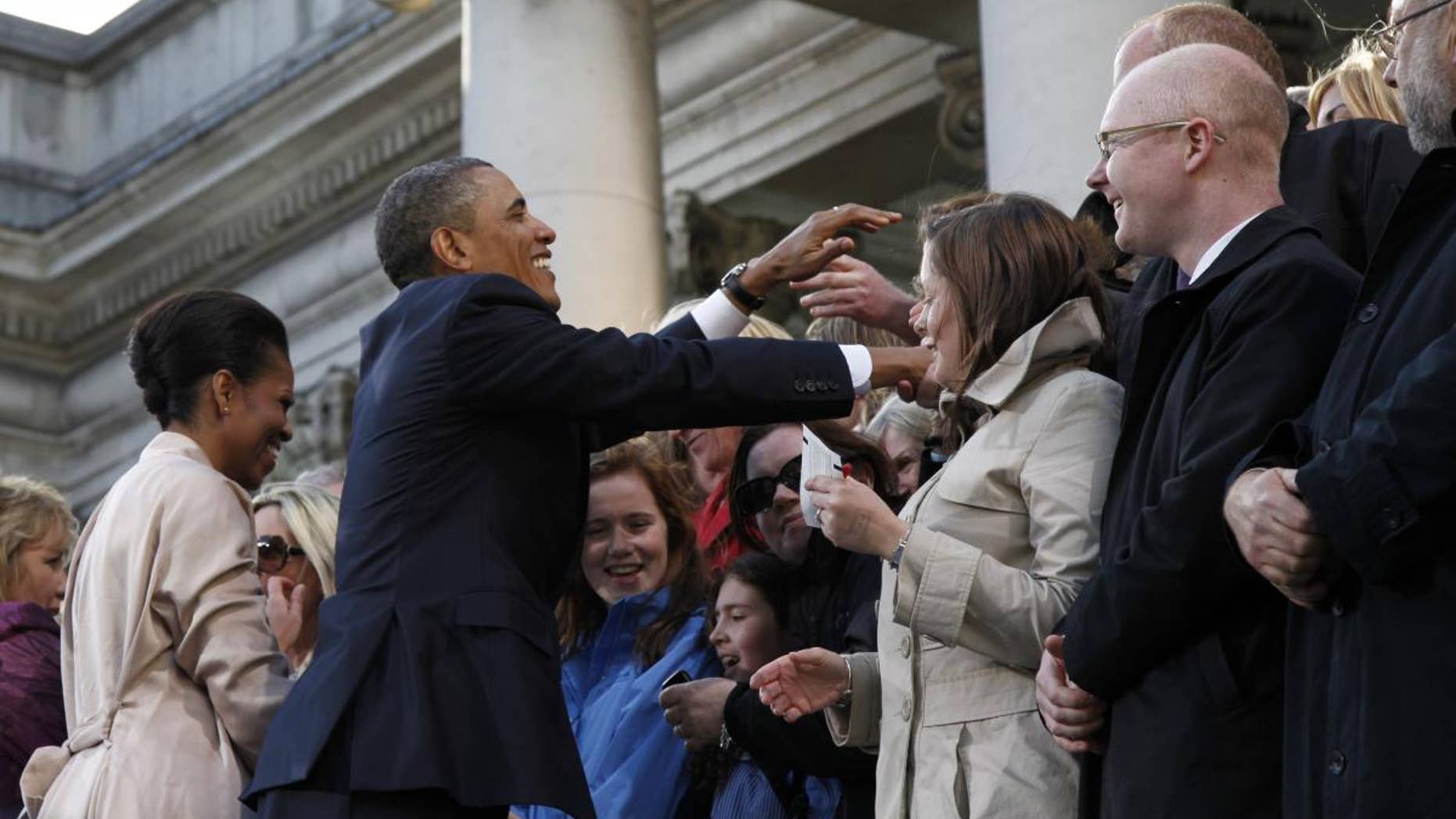 U.S. President Barack Obama and first lady Michelle Obama greet the crowd at College Green in Dublin, Ireland, Monday, May 23, 2011. (AP Photo/Charles Dharapak)