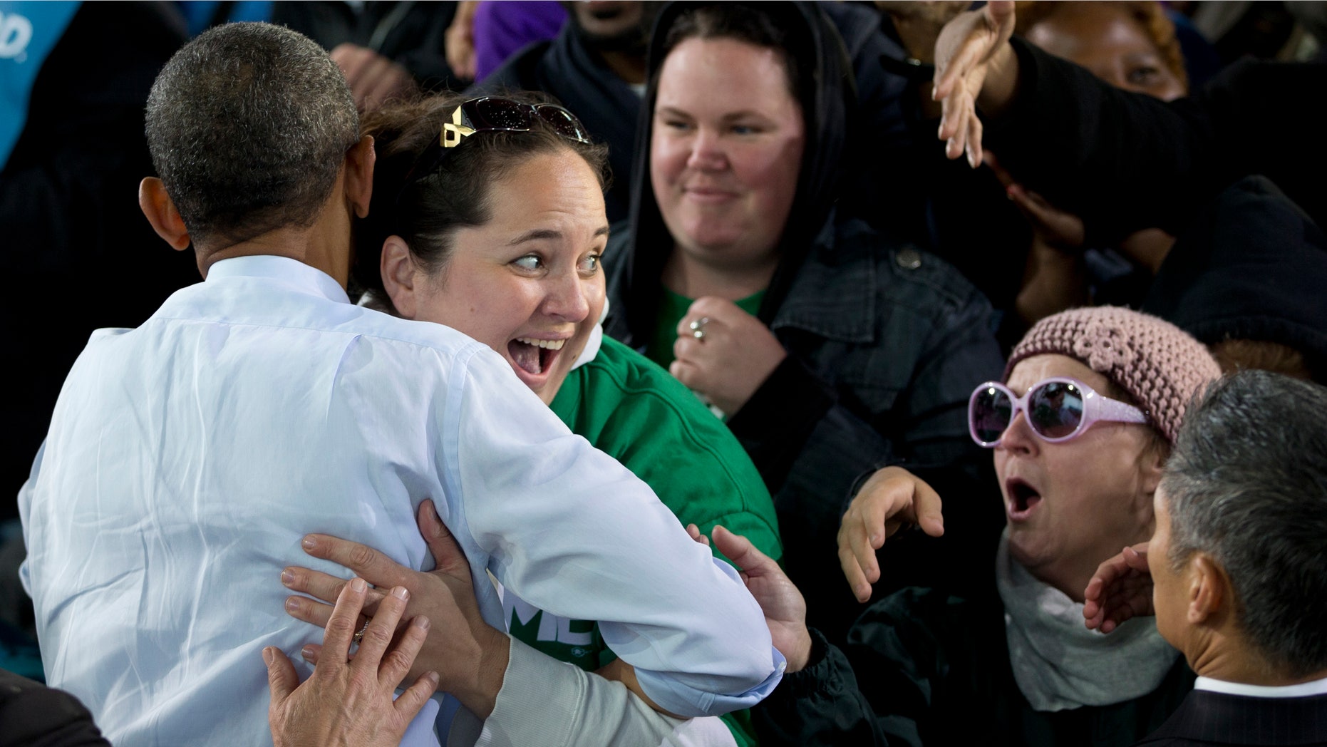 Saturday, Sept. 22, 2012: President Obama is hugged by a woman as he greets people at a campaign event in Milwaukee.