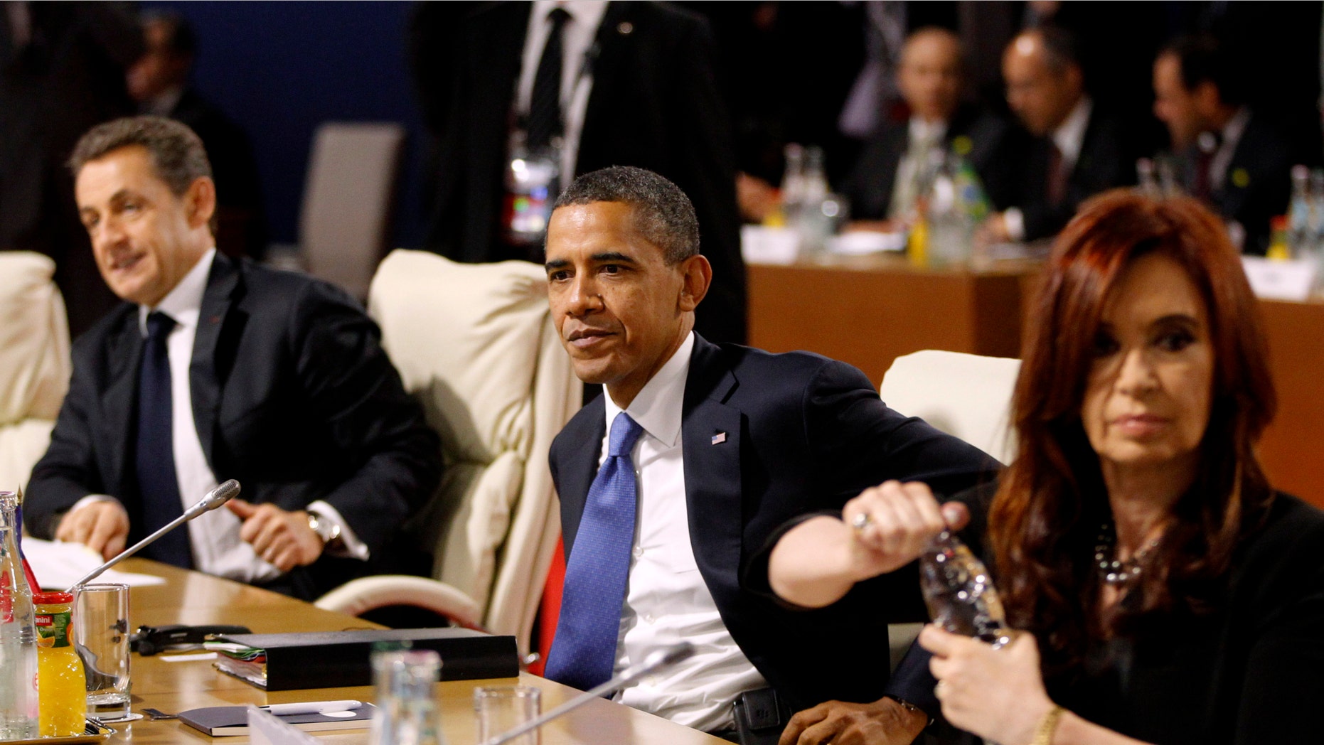 President Barack Obama, center, flanked by French President Nicolas Sarkozy, left, and Argentina President Cristina Fernandez is seen during a working lunch at the G20 Summit in Cannes, France, Thursday, Nov. 3, 2011. (AP Photo/Charles Dharapak)