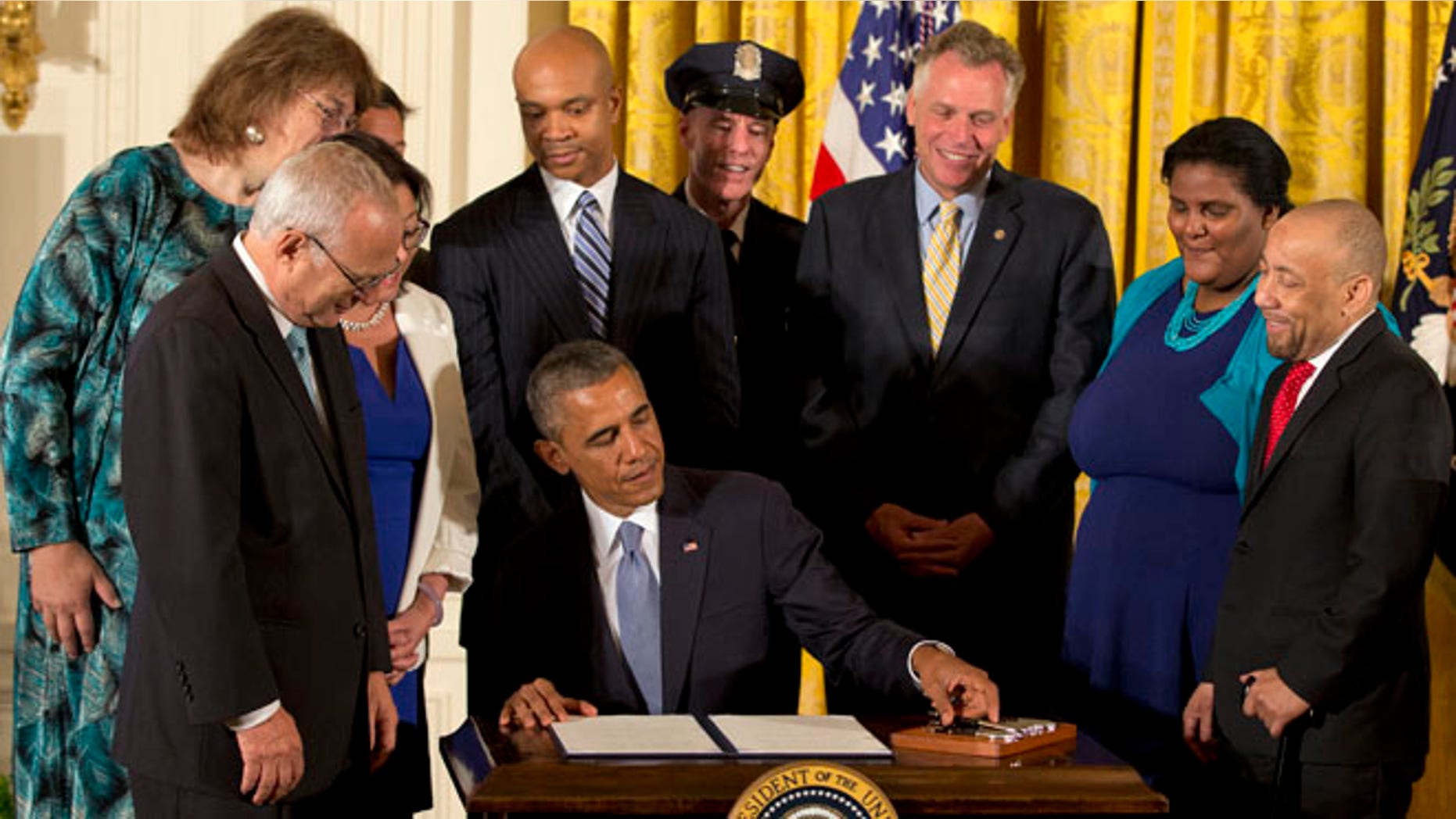 July 21, 2014: President Obama signs executive orders to protect LGBT employees from federal workplace discrimination in the East Room of the White House.