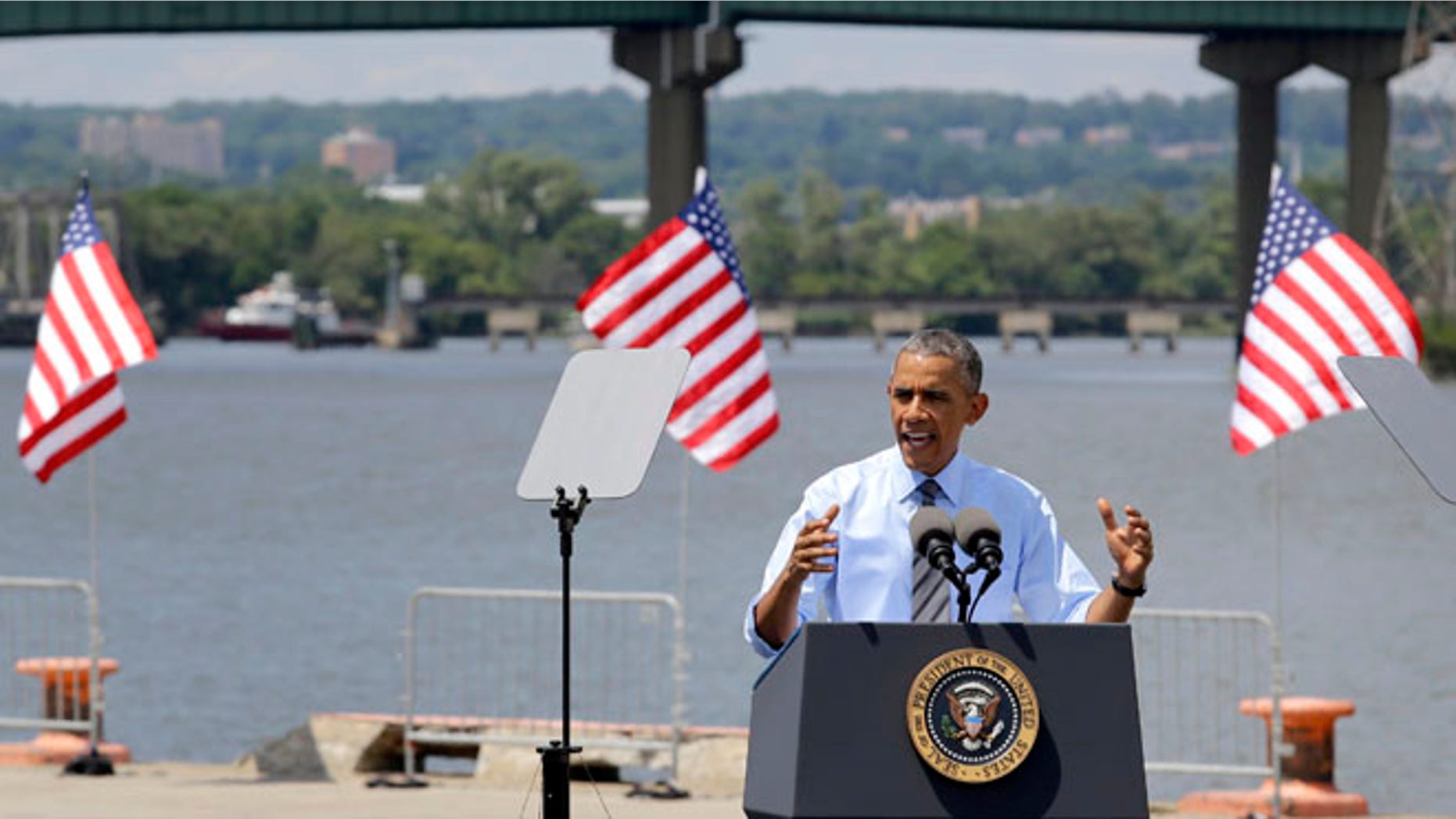 President Barack Obama speaks in front of the Interstate 495 bridge over the Christina River near Wilmington, Del., Thursday, July 17, 2014.