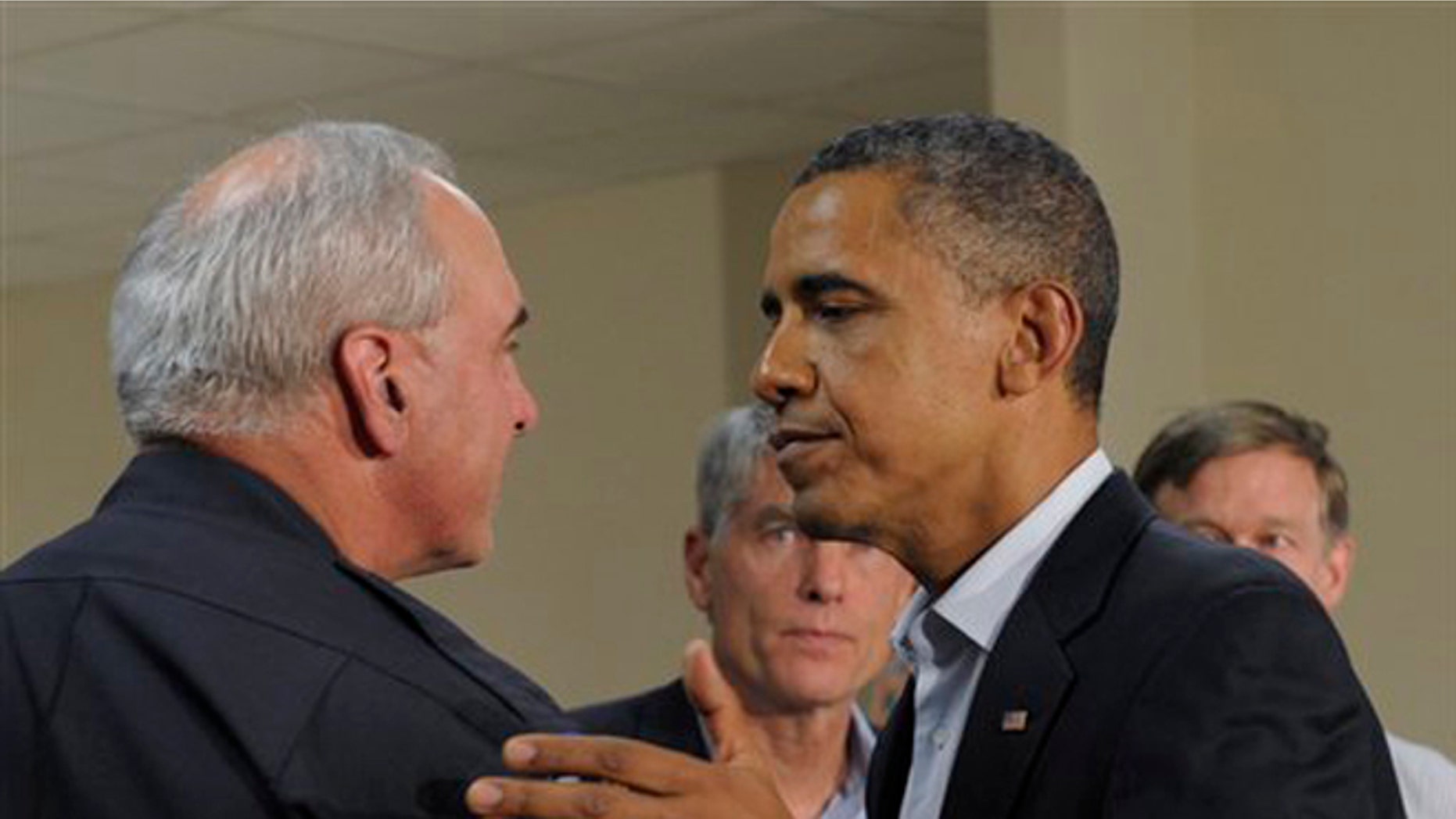 July 22, 2012: President Obama talks to Aurora, Colo., Police Chief Dan Oates after making a statement from the University of Colorado Hospital.