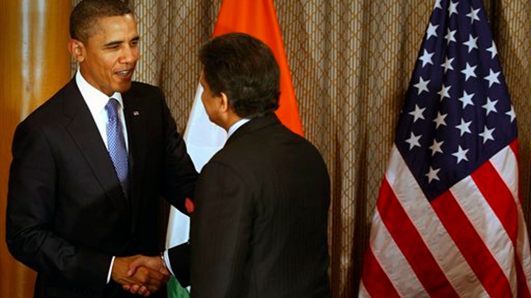 U.S. President Barack Obama, left, shakes hand with Mahindra & Mahindra Ltd. Managing Director Anand Mahindra at Obama's meeting with entrepreneurs in Mumbai, India, Saturday, Nov. 6, 2010. Obama arrived in India on Saturday, beginning a 10-day, four-country tour of Asia that will take him through some of the region's most vibrant democracies in search of U.S. economic and security benefits. (AP Photo/Rafiq Maqbool, Pool)