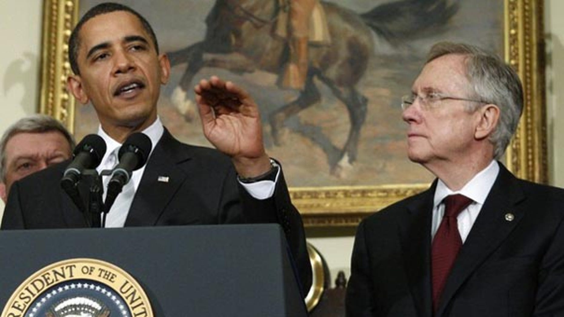 In this December 15, 2009 file photo, President Obama makes remarks on his meeting with Democratic senators about health care legislation as Senate Majority leader Harry Reid listens in the Roosevelt Room at the White House. (Reuters)