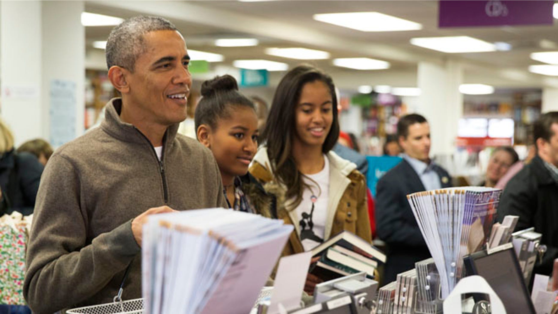 Nov. 29, 2014: President Obamashops with daughters, Sasha, center, and Malia, at Politics and Prose bookstore, in Washington, D.C.