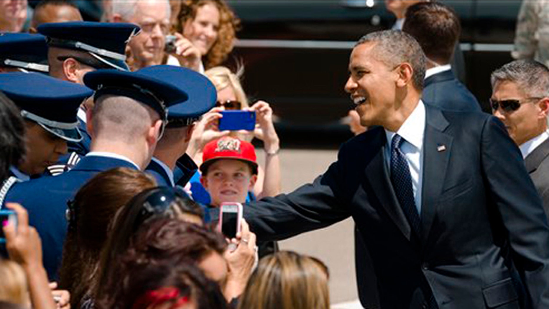 July 23, 2012: President Obama shakes hands with supporters after he arrives at the Reno National Guard airport in Nevada.