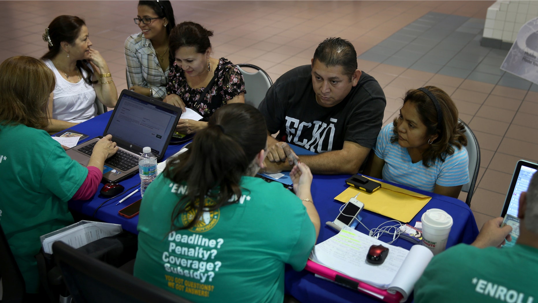 MIAMI, FL - DECEMBER 22: Rene Hernandez (2nd R) and his wife Nery Hernandez speak with Rosaly Hernandez an insurance agent with Sunshine Life and Health Advisors as they try to purchase health insurance under the Affordable Care Act at the kiosk setup at the Mall of Americas on December 22, 2013 in Miami, Florida. Tomorrow is the deadline for people to sign up if they want their new health benefits to kick in on the 1st of January. People have until March 31, to sign up for coverage that would start later. (Photo by Joe Raedle/Getty Images)