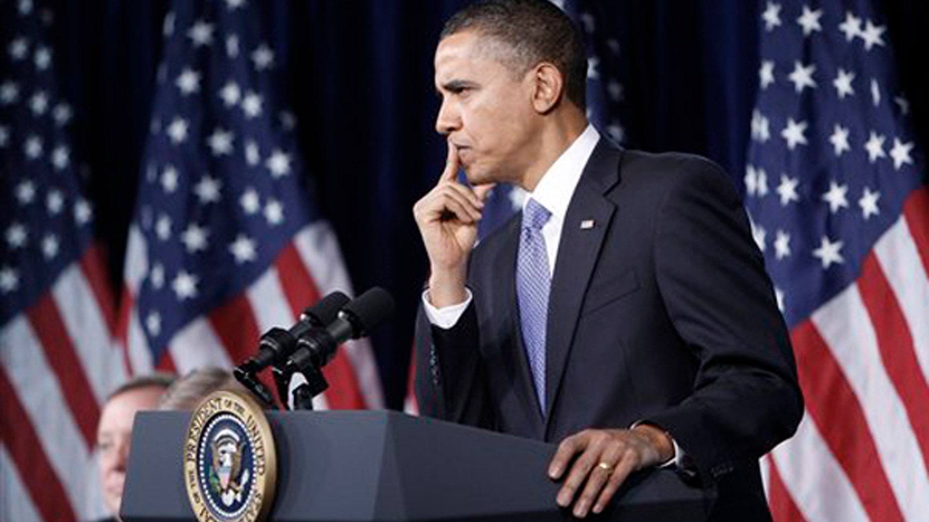 Feb. 3: President Barack Obama pauses as he listens to a questions from Sen. Arlen Specter, D-Pa., while attending the Senate Democratic Policy Committee Issues Conference at the Newseum in Washington.