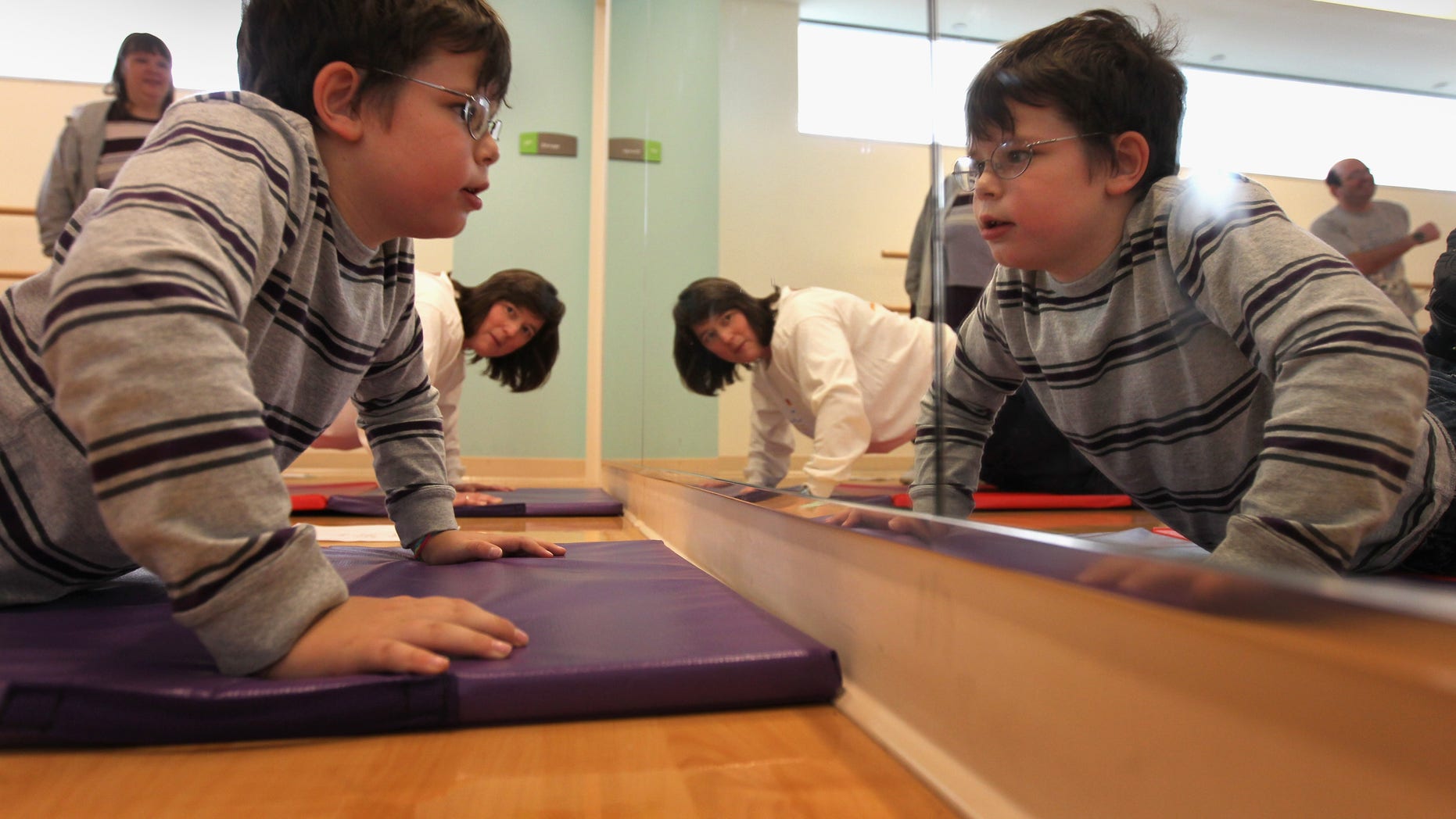 Morgan DePalma does push-ups during the Shapedown program for overweight adolescents and children in Aurora, Colorado.