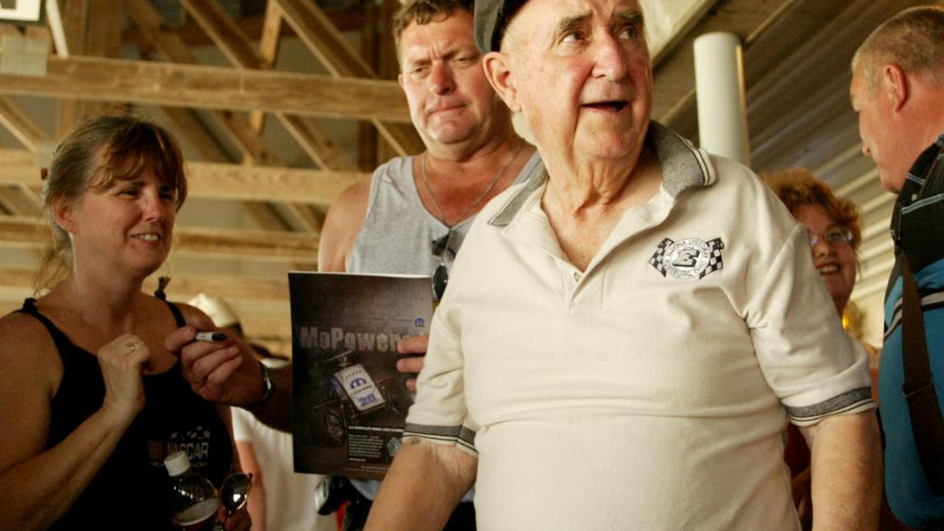 In this June 8, 2005, photo, Earl Baltes, right, is shown at Eldora Speedway in Rossburg, Ohio. Earl Baltes, the founder and longtime promoter of Eldora Speedway, has died. He was 93. Speedway officials say Baltes died Monday, March 23, 2015, at Miami Valley Hospital in Dayton, Ohio. Eldora owner and three-time NASCAR champion Tony Stewart says Baltes "was the yardstick other track promoters measured themselves by. He constantly raised the bar, and he did it by creating events everyone else was afraid to promote. He did them himself, too." (AP Photo/Dayton Daily News, Jan Underwood, File)