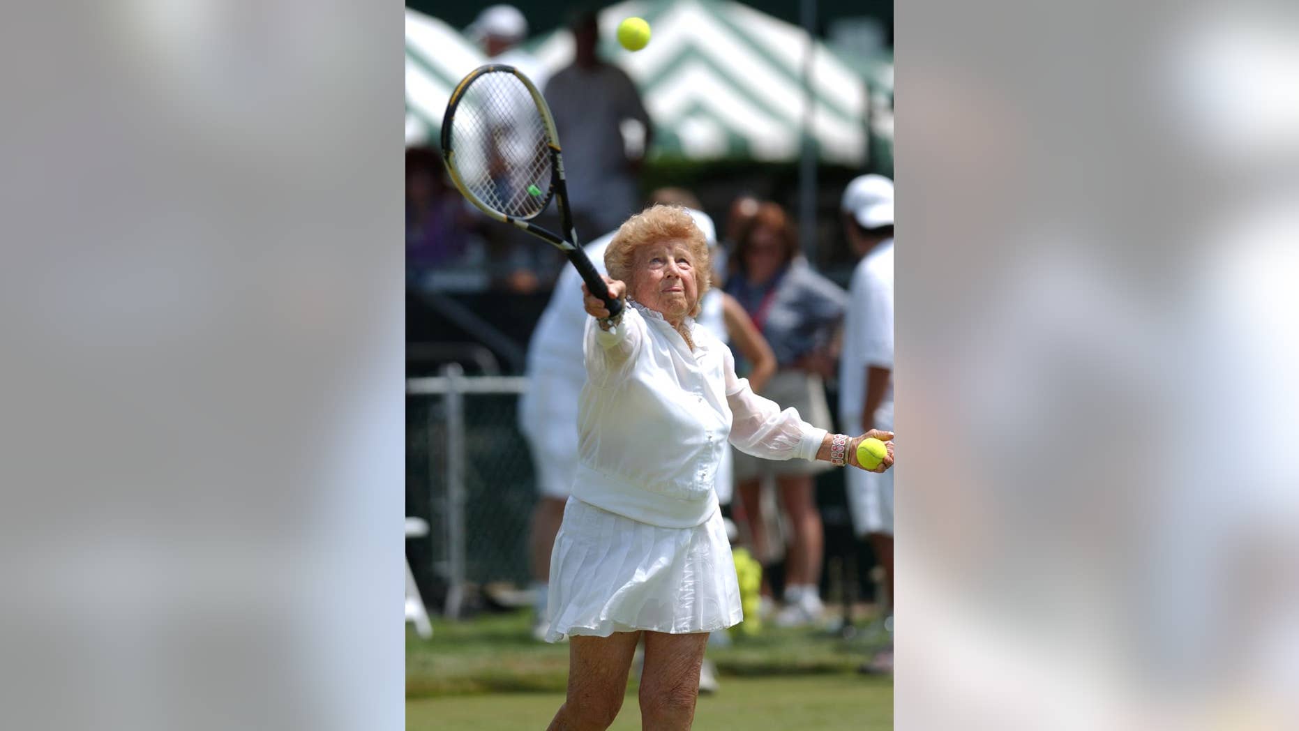 FILE - In this July 10, 2004, file photo, Tennis great Dorothy "Dodo" Cheney, 87, of Santa Monica, Calif., plays during an exhibition match prior to ceremonies celebrating the 50th anniversary of the Tennis Hall of Fame in Newport, R.I. The International Tennis Hall of Fame says Cheney, a member of the Hall and the first American woman to win the tournament now known as the Australian Open, has died at age 98. The Hall says Tuesday, Nov. 25, 2014, that Cheney died Sunday in Escondido, Calif., following a brief illness. (AP Photo/Victoria Arocho, File)