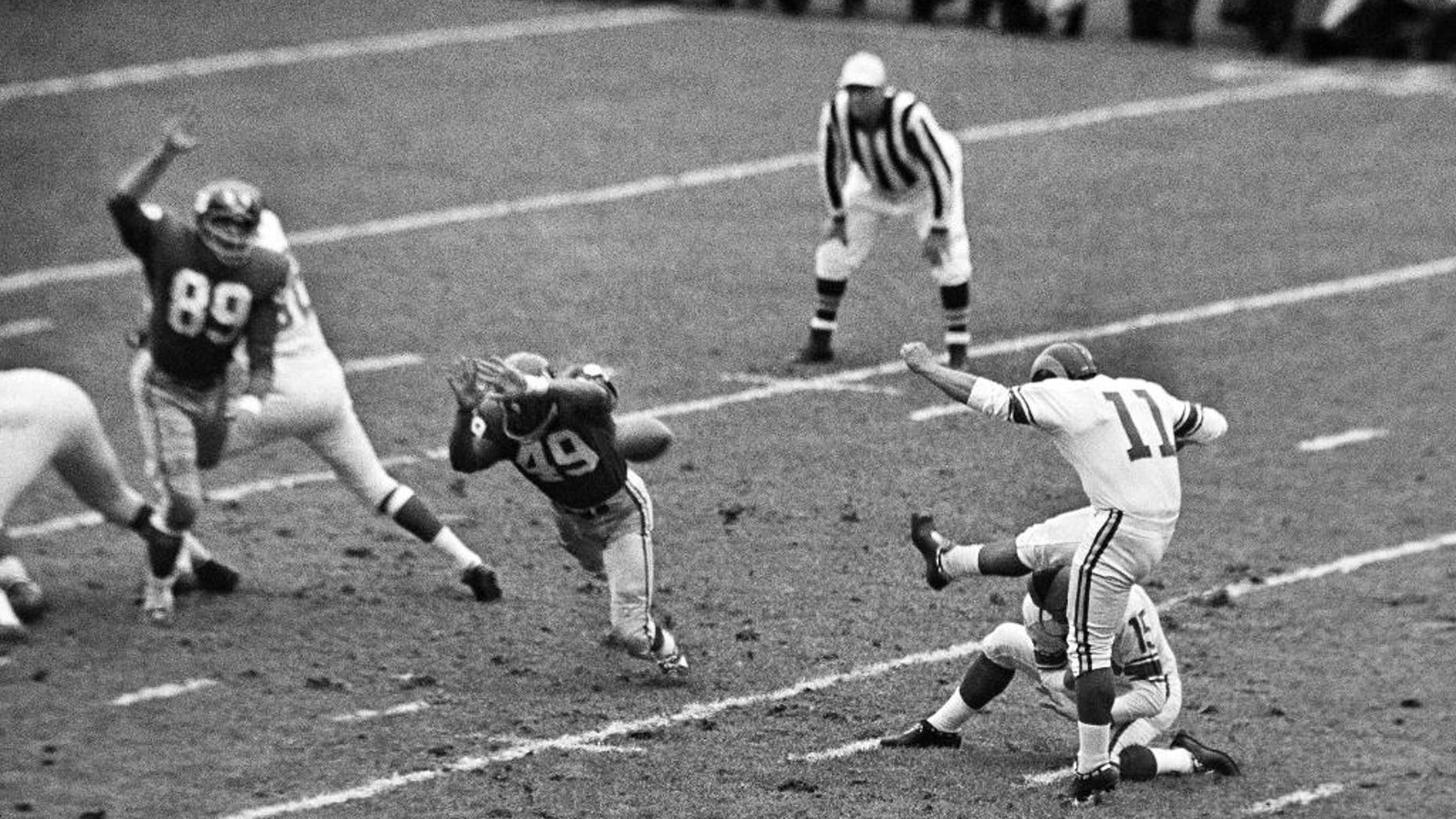FILE - In this Oct. 22, 1961, file photo, New York Giants halfback Erich Barnes (49) blocks field goal-attempt by Los Angeles Rams' Danny Villanueva (11) in the first period of NFL game in New York's Yankee Stadium. Villanueva, who was one of the NFL’s first Latino kickers and a pioneer of Spanish-language television, has died. He was 77. Family members and officials at New Mexico State University, where Villanueva was a member of the athletic hall of fame, confirmed that he died Thursday, June 18, 2015, after suffering a stroke earlier this week. (AP Photo, File)